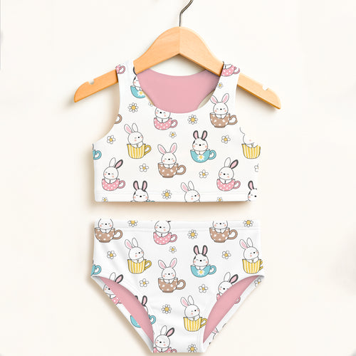 Girls bunny teacup two piece swimsuit in white with pink lining and colorful yellow blue and brown teacups design