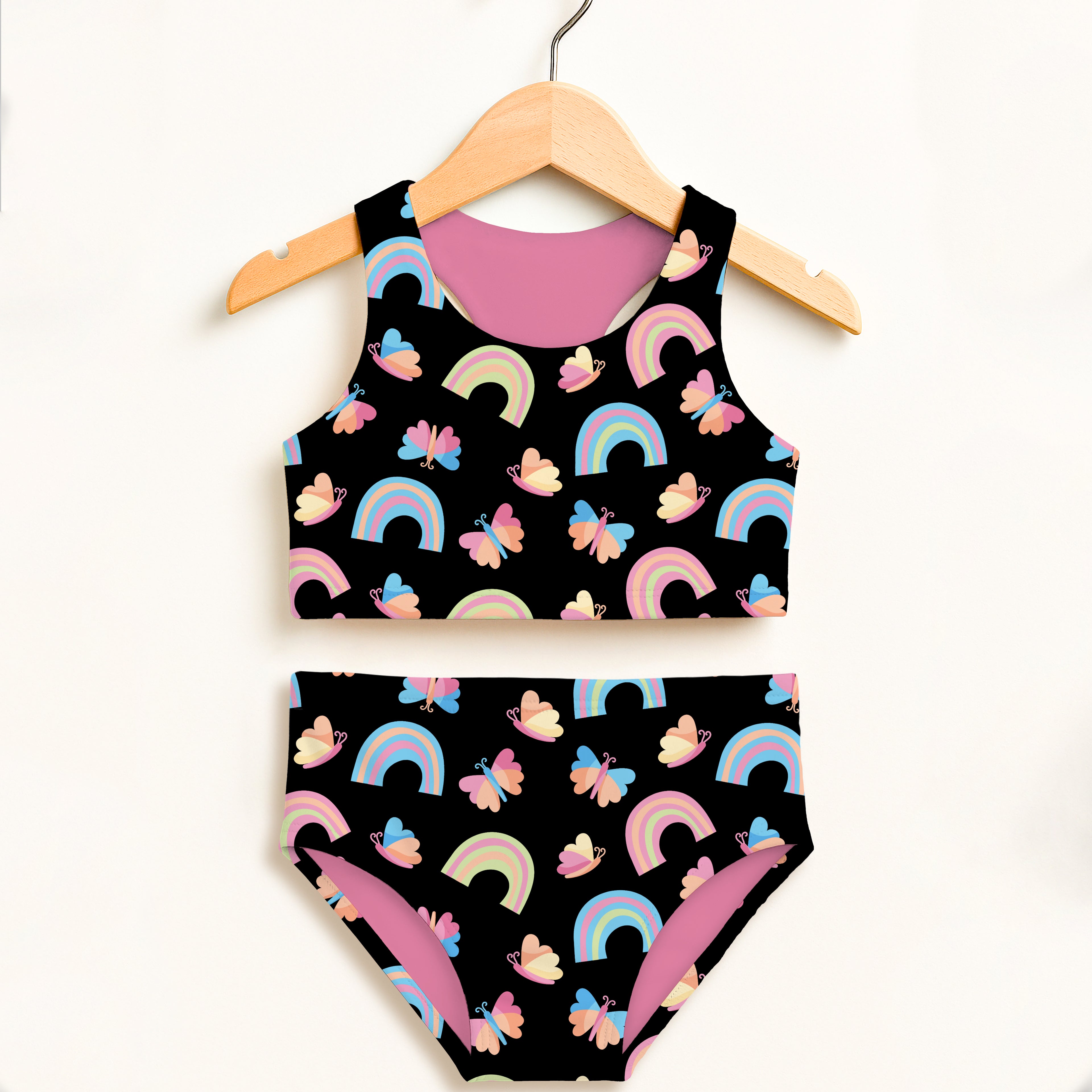 Girls rainbow butterfly two piece swimsuit in black and pink with double layered upf 50 high waisted comfort on wooden hanger