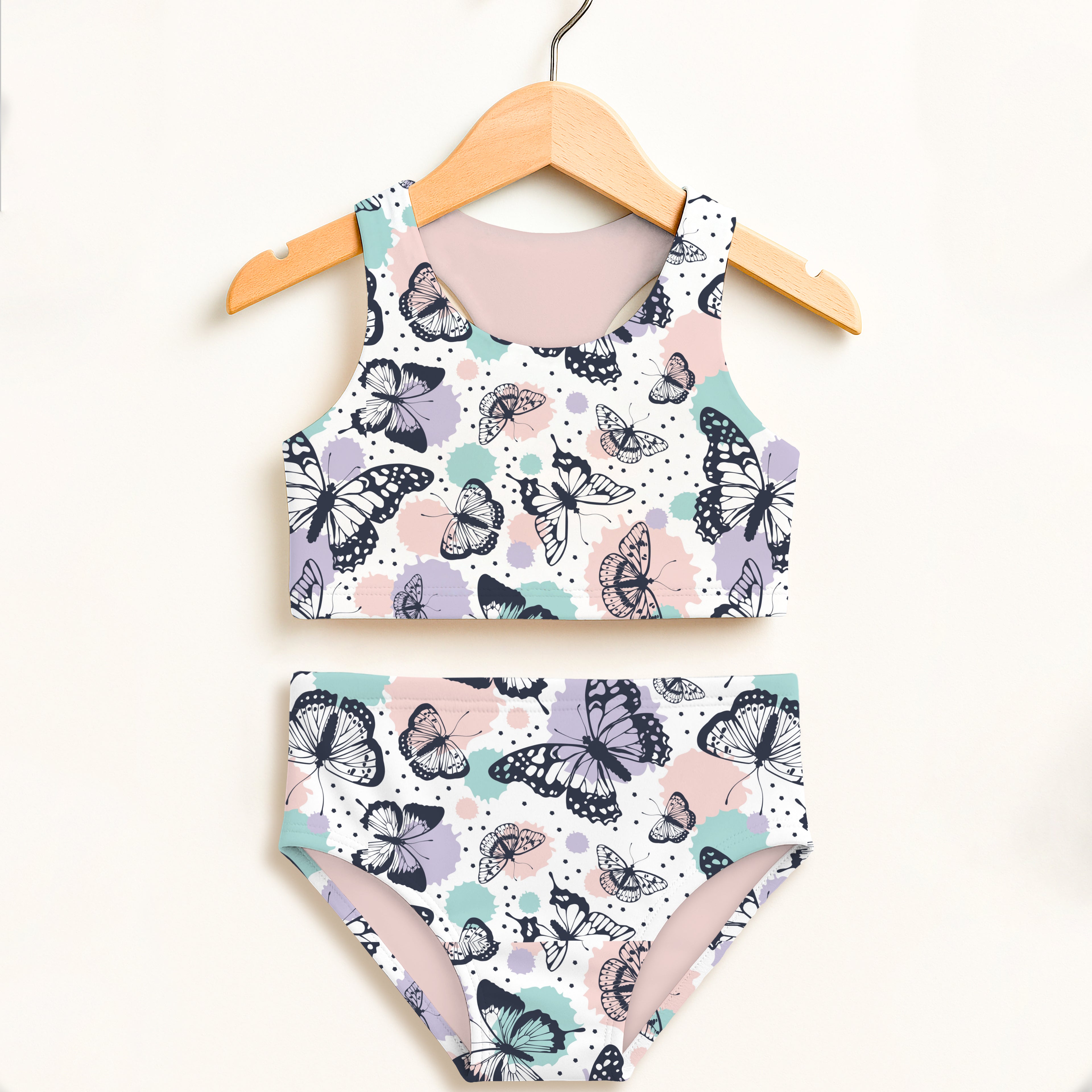 Girls butterfly two piece swimsuit with black outlined butterflies mint and blush splashes on white double layered upf 50+