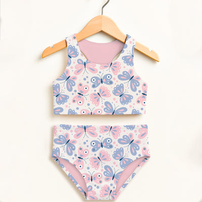 A girls two-piece swimsuit with playful butterfly print in pink and lavender on white double layered upf 50+ fabric