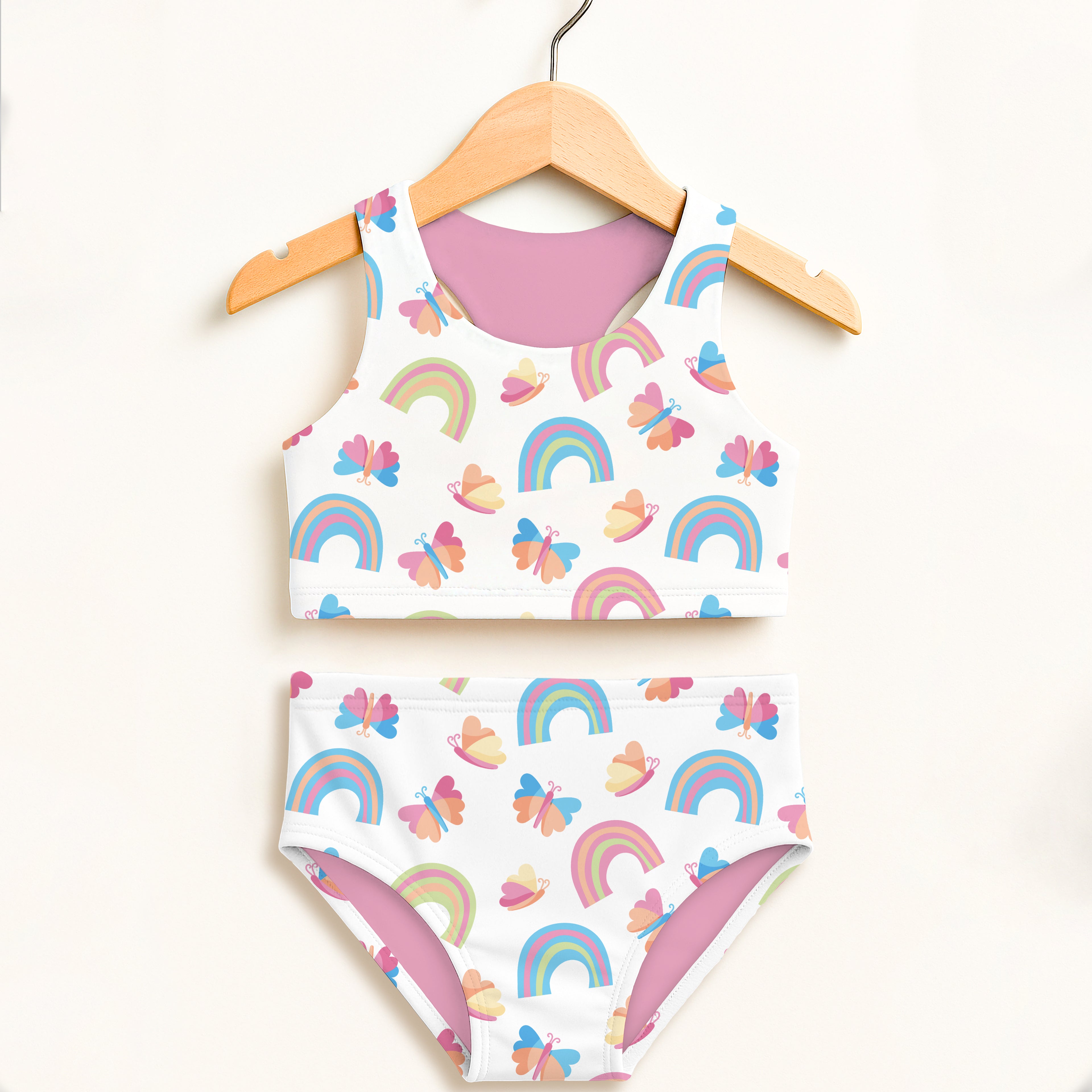 Girls rainbows and butterflies two piece swimsuit in white with playful rainbow and butterfly pattern and pink lining
