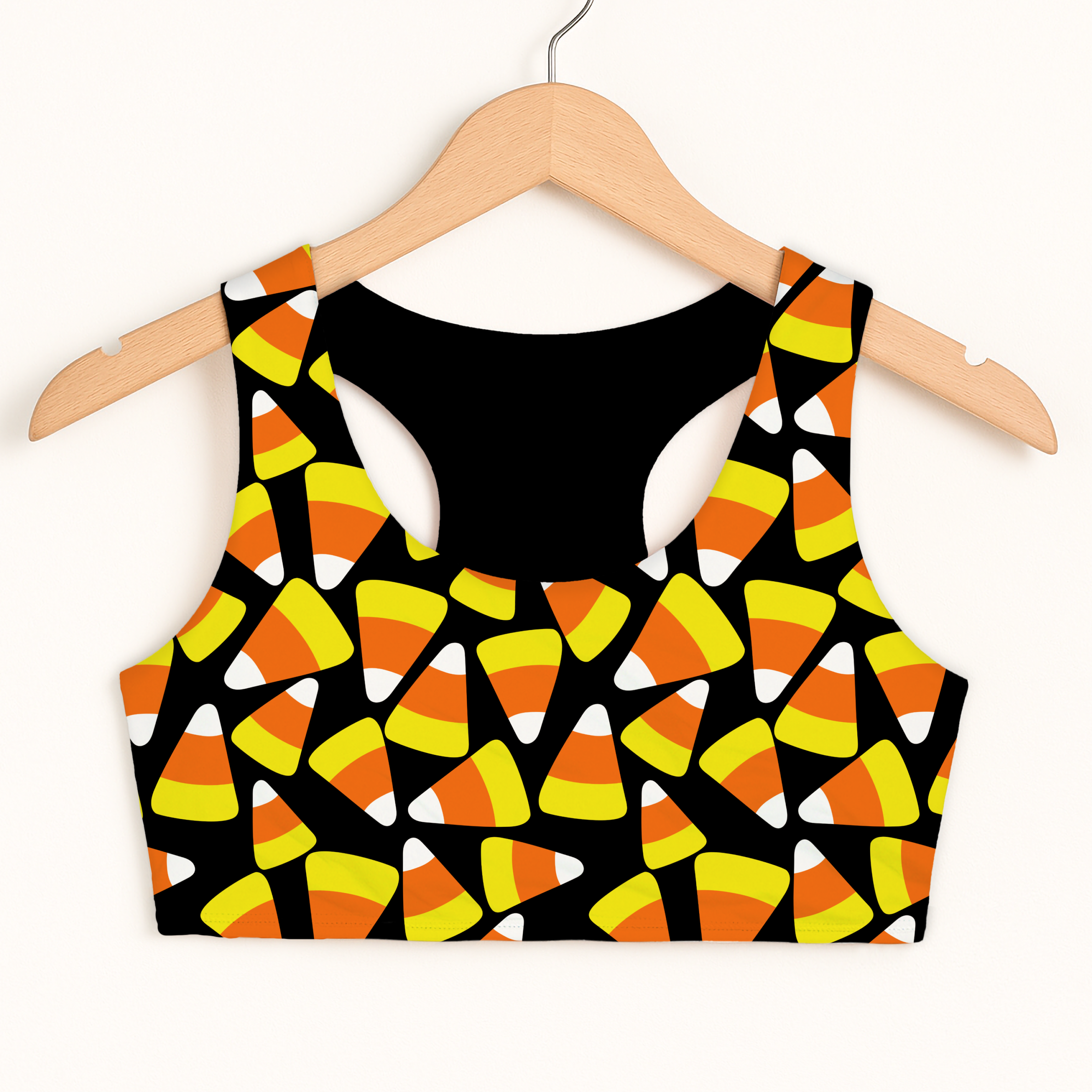 Girls candy corn Halloween sports bra in black with playful orange yellow white pattern quick drying double layered comfort