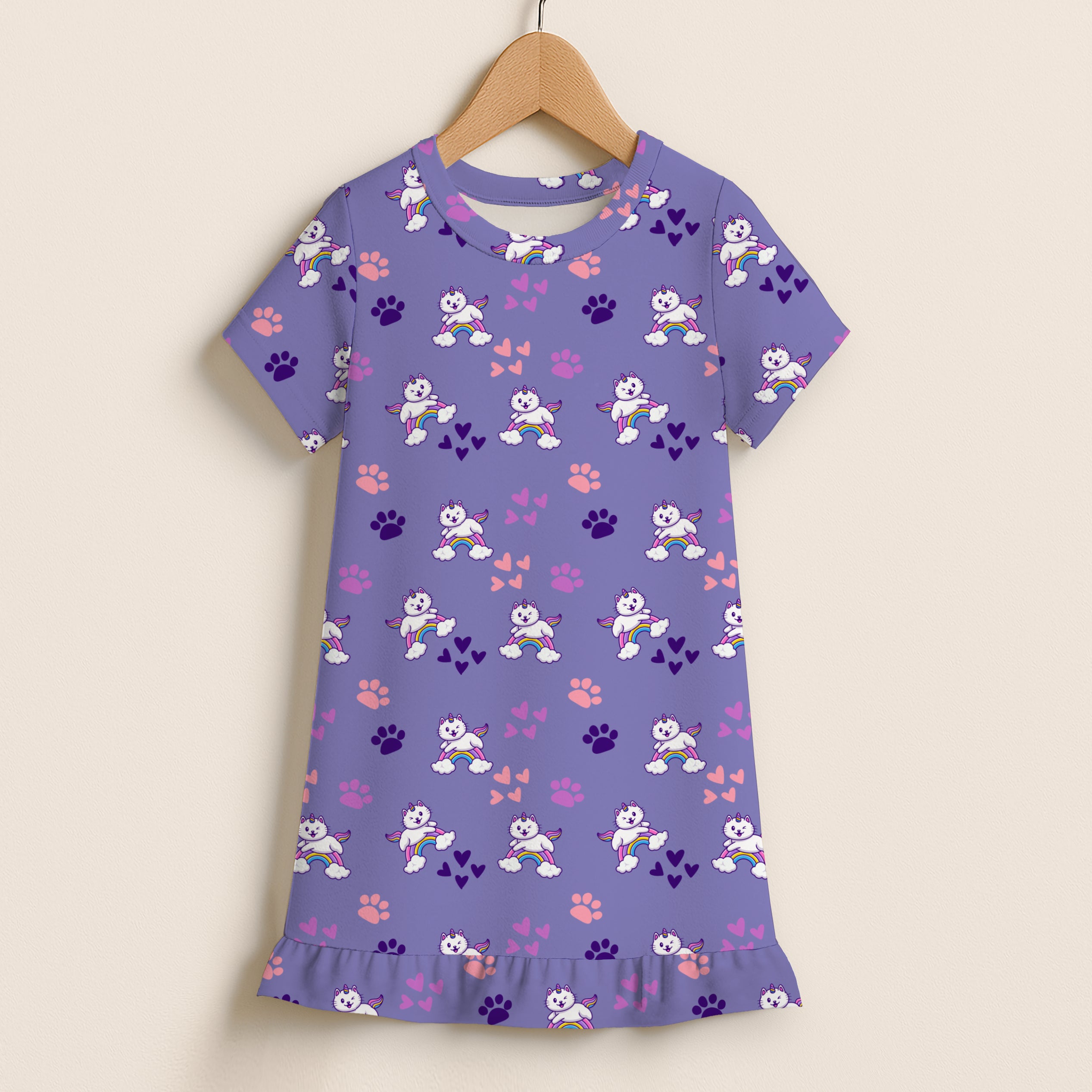 Girls caticorn rainbow short sleeve ruffle hem dress in purple with white cat, rainbow, paw print, and heart patterns