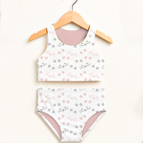 Girls cat paw print two-piece swimsuit with pink and gray paw prints, whiskers, soft mauve lining, and UPF 50+ protection