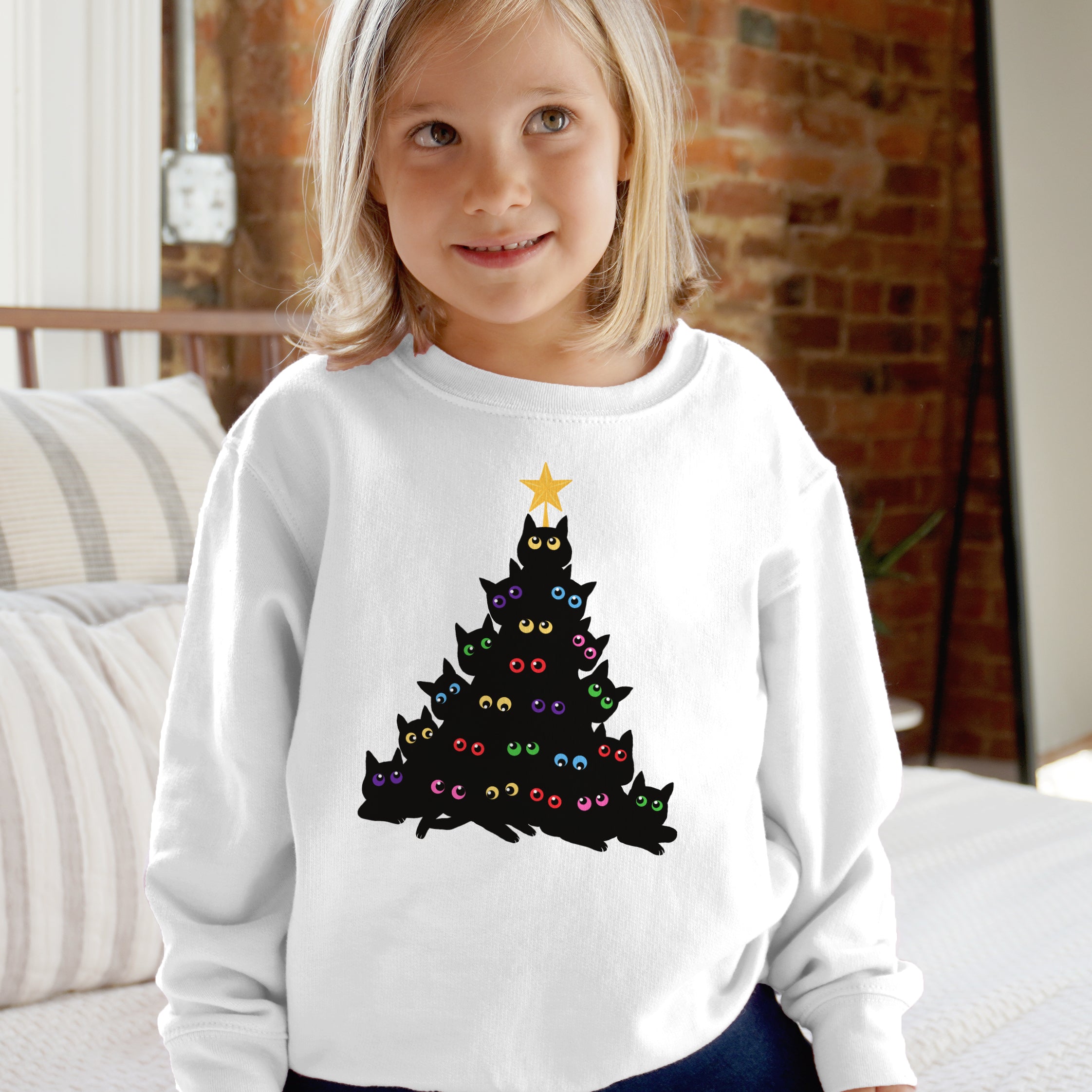 White long-sleeved kids sweatshirt with black cat christmas tree design featuring colorful eyes and yellow star