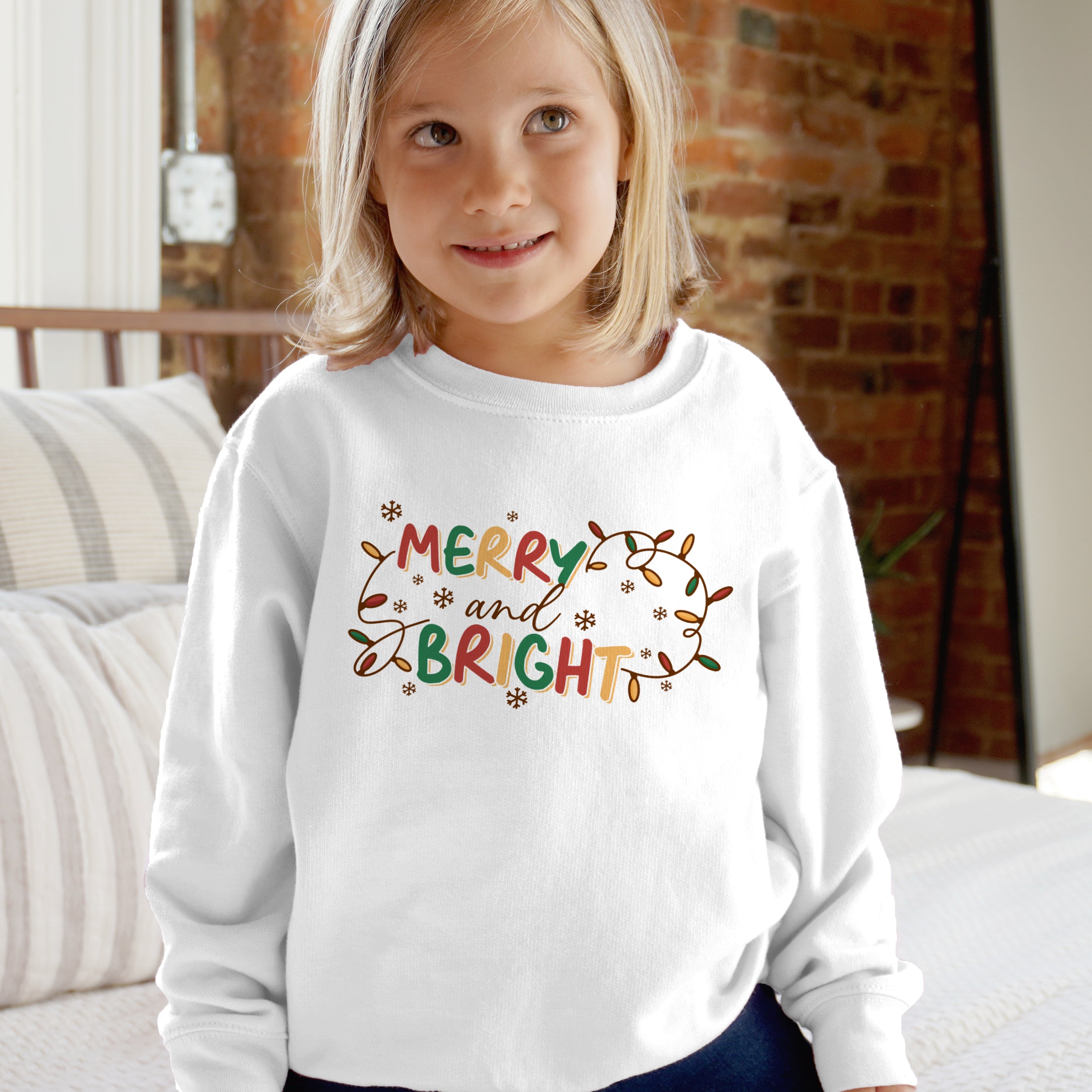 White long-sleeved kids sweatshirt with merry and bright colorful festive lettering and holiday lights design