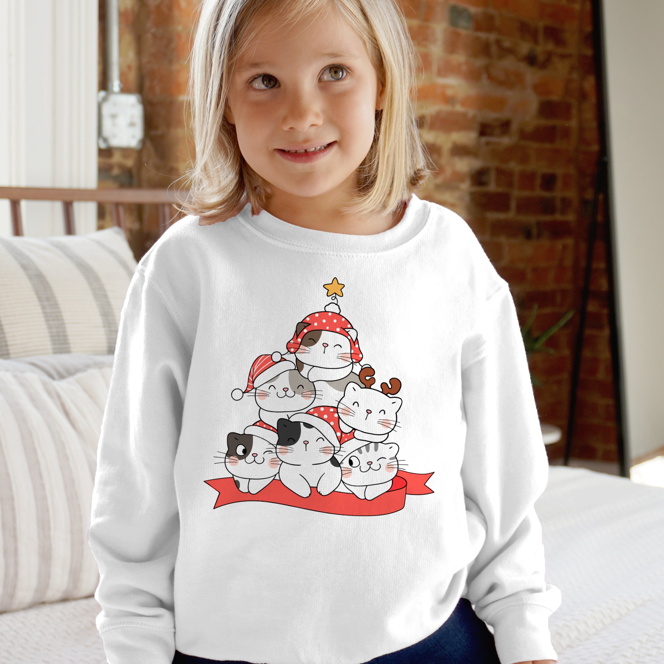 White long-sleeved kids sweatshirt with festive cartoon cats in holiday hats arranged like a christmas tree design