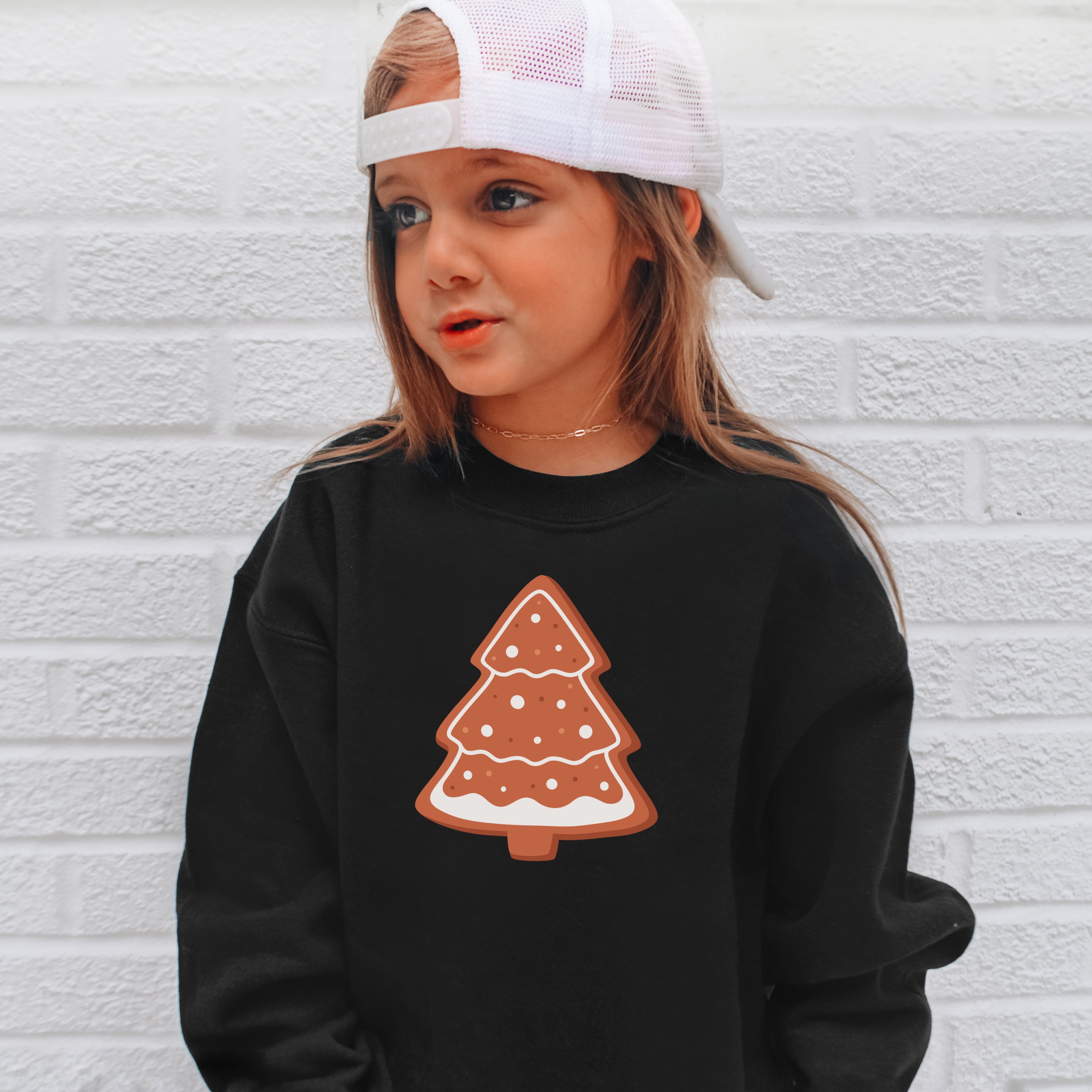 Black kids sweatshirt with festive gingerbread christmas tree graphic and white icing details for holiday wear