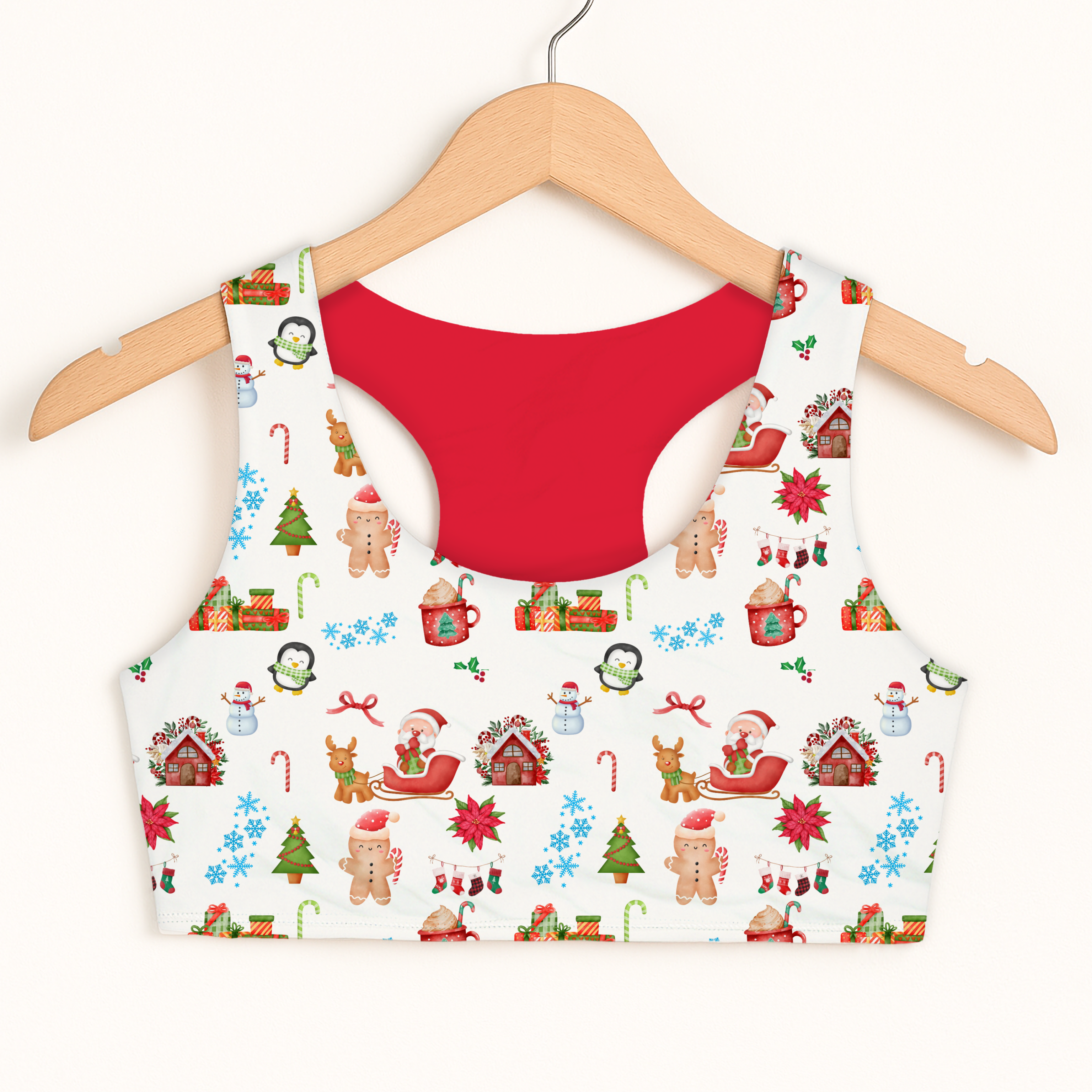 White girls christmas pattern sports bra with red interior featuring snowmen gingerbread men reindeer and holiday houses