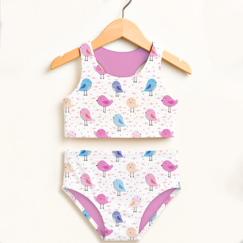 A charming white two-piece girls swimsuit with pastel birds and hearts pattern featuring upf 50 plus high waist design