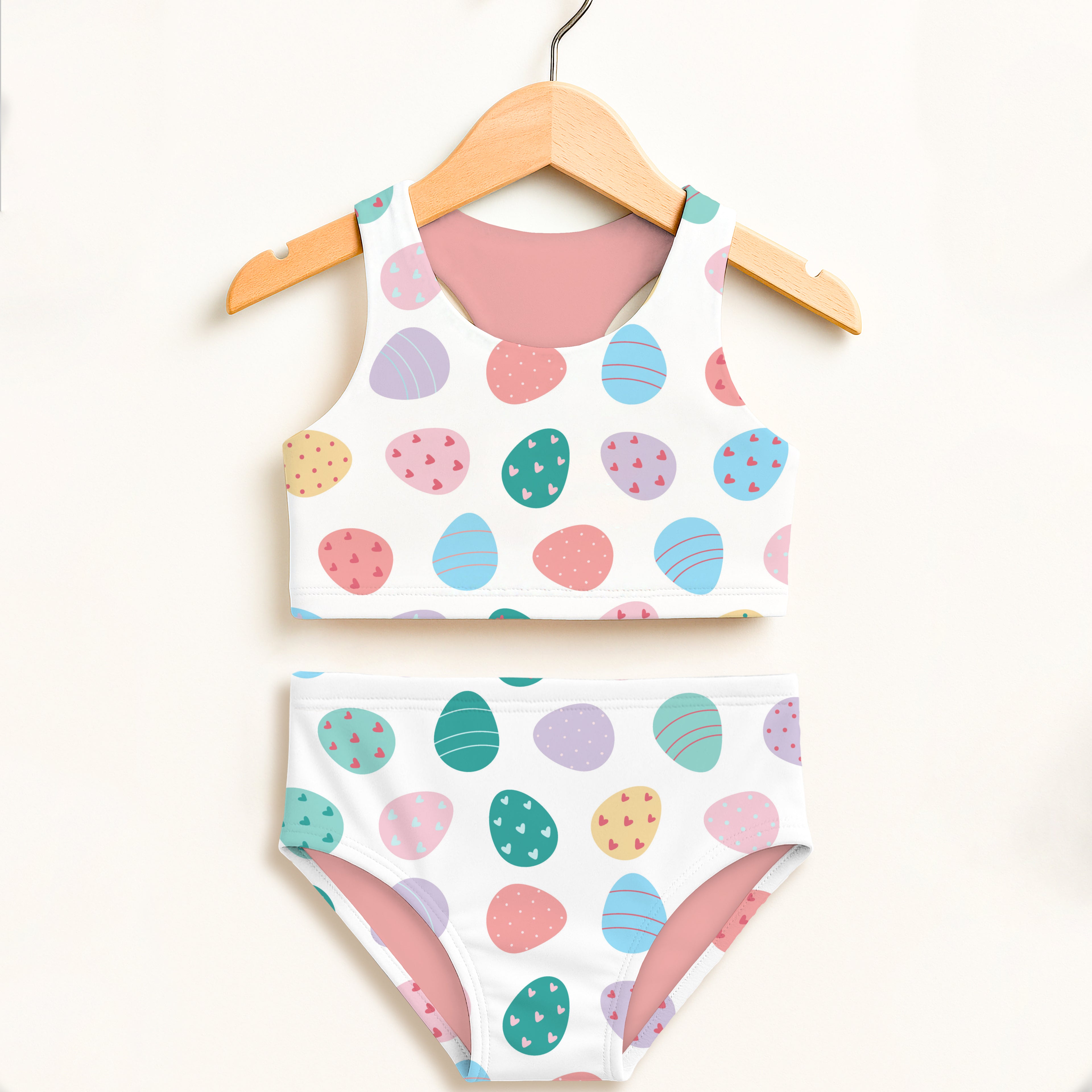 Girls easter egg print two piece swimsuit with pastel colors white base pink lining and upf 50 plus high waisted comfort