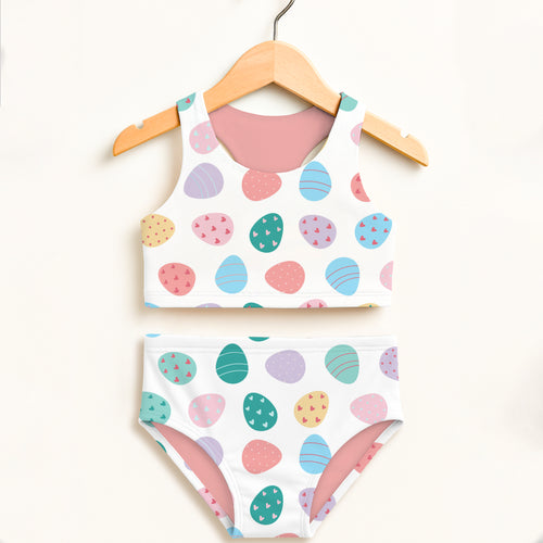 Girls easter egg print two piece swimsuit with pastel colors white base pink lining and upf 50 plus high waisted comfort