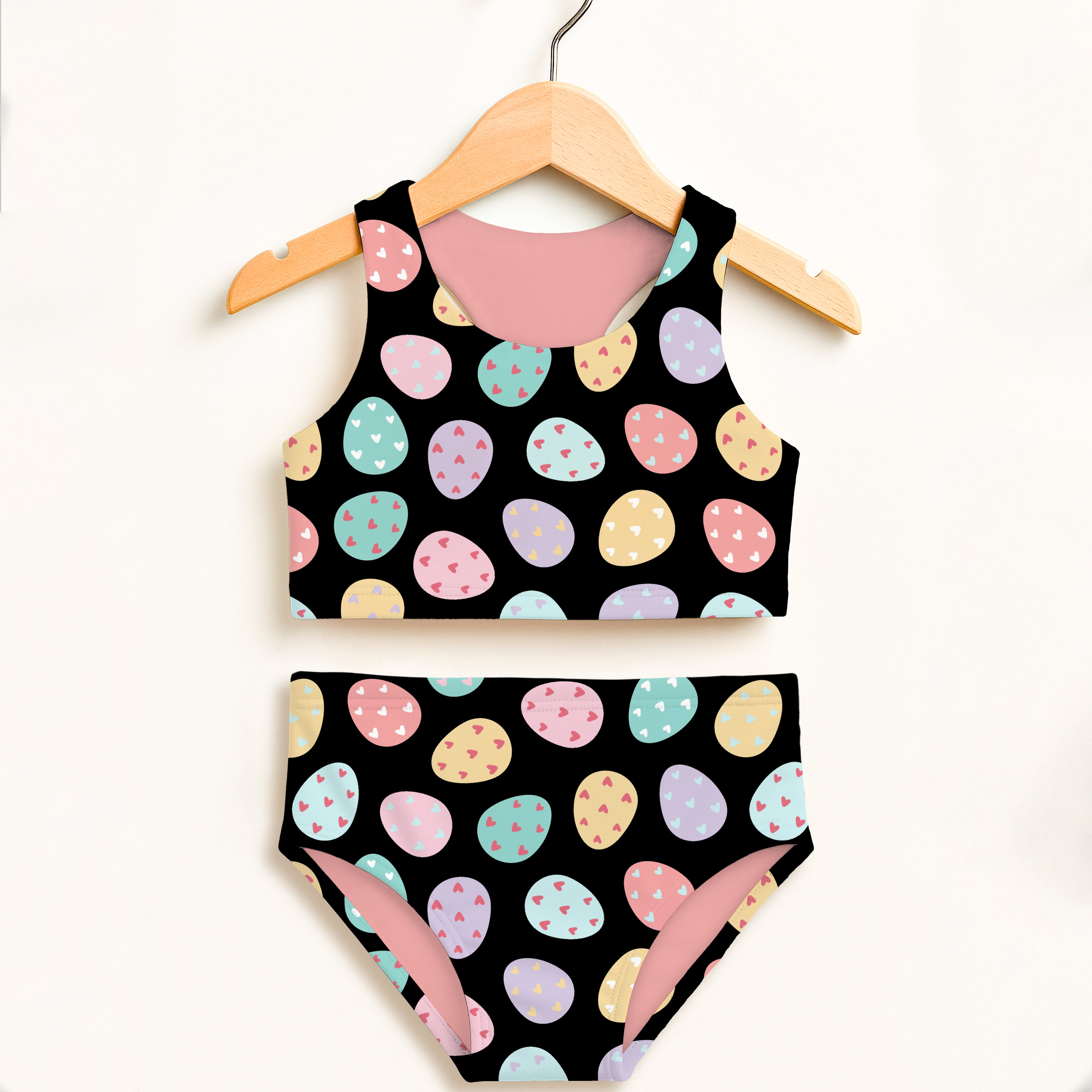 Girls colorful eggs two piece swimsuit in black with pastel easter egg pattern tiny hearts pink lining and upf 50+ protection