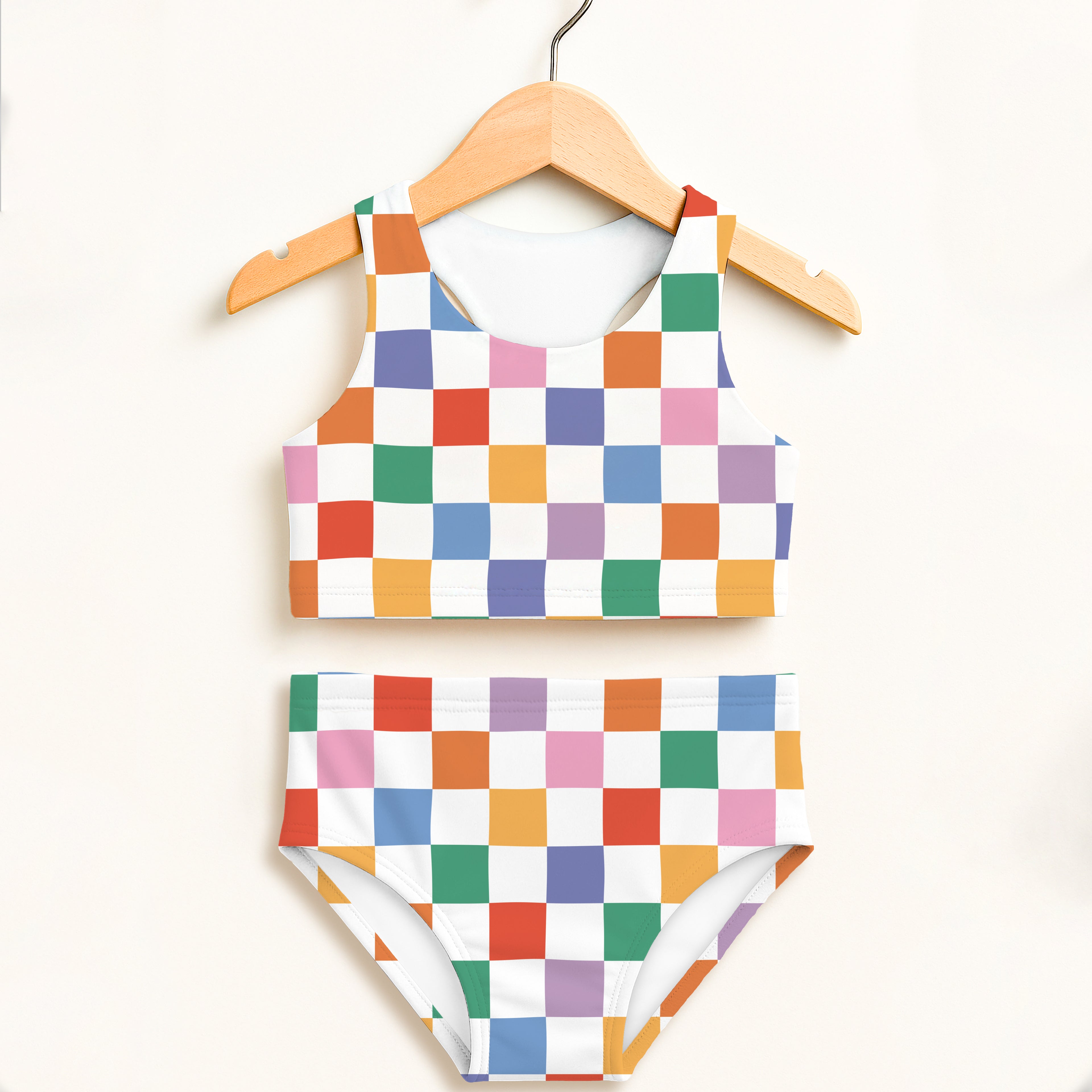Girls colorful checkerboard two piece swimsuit with halter top and high waisted bottoms in vibrant rainbow squares
