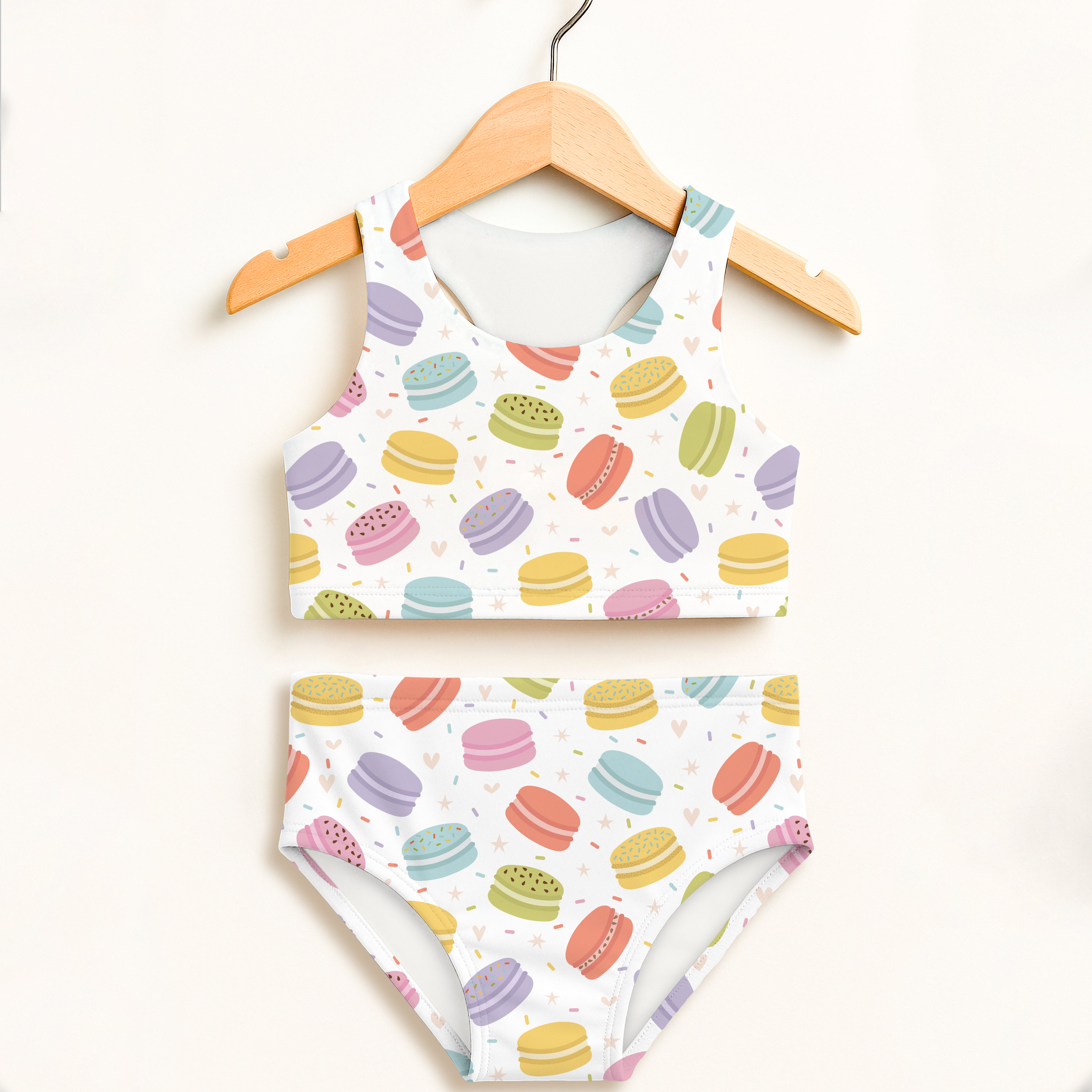 Girls macaron cookie sprinkles two piece swimsuit featuring white fabric with colorful pastel macarons and sprinkles print