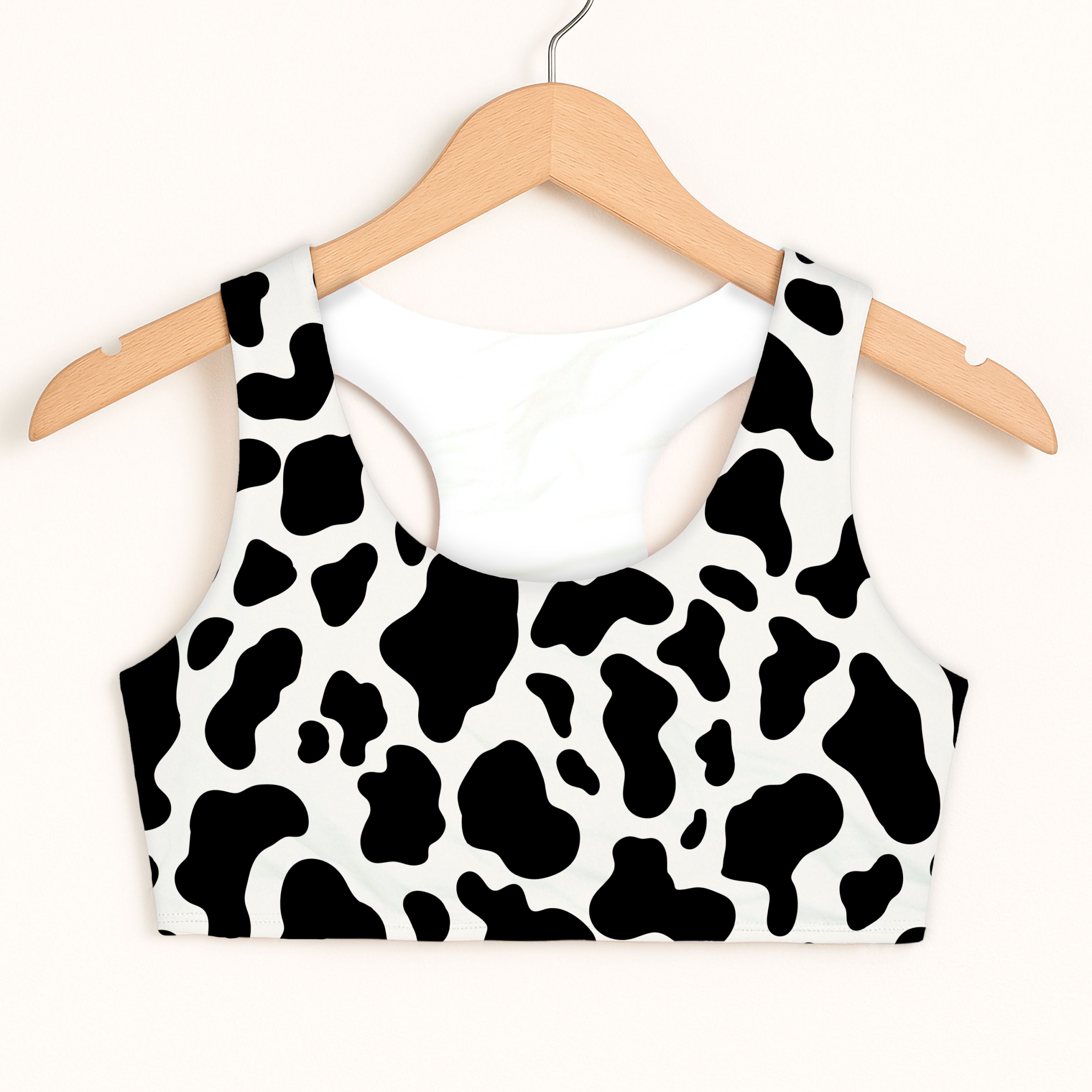 Girls cow print sports bra quick drying double layered comfort black and white hanging on wooden hanger