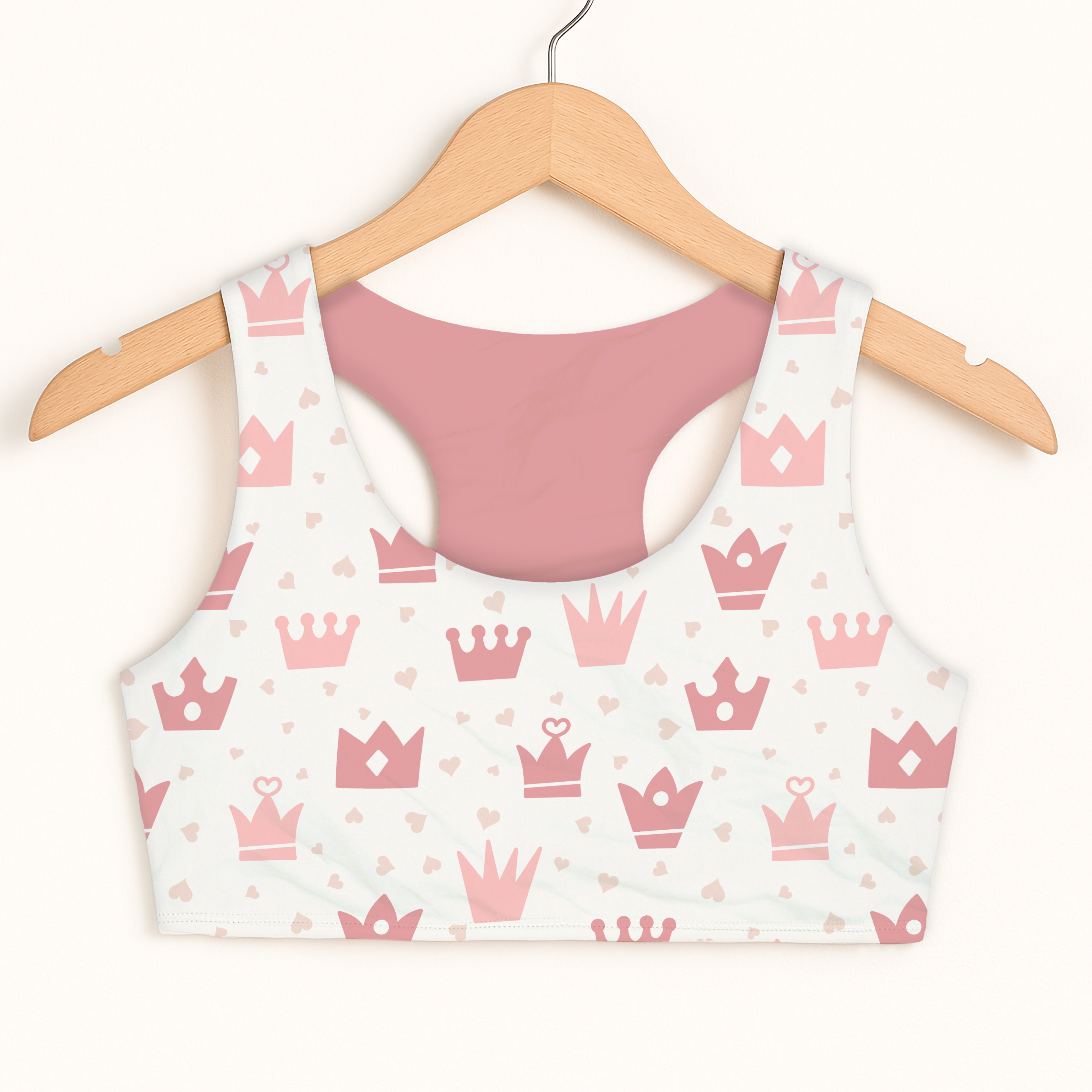A girls pink crowns sports bra with quick drying fabric white front with pink crown and heart pattern and blush back panel
