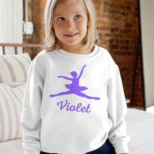 Child wearing a white sweatshirt with a purple ballerina design and the name 'Violet'.