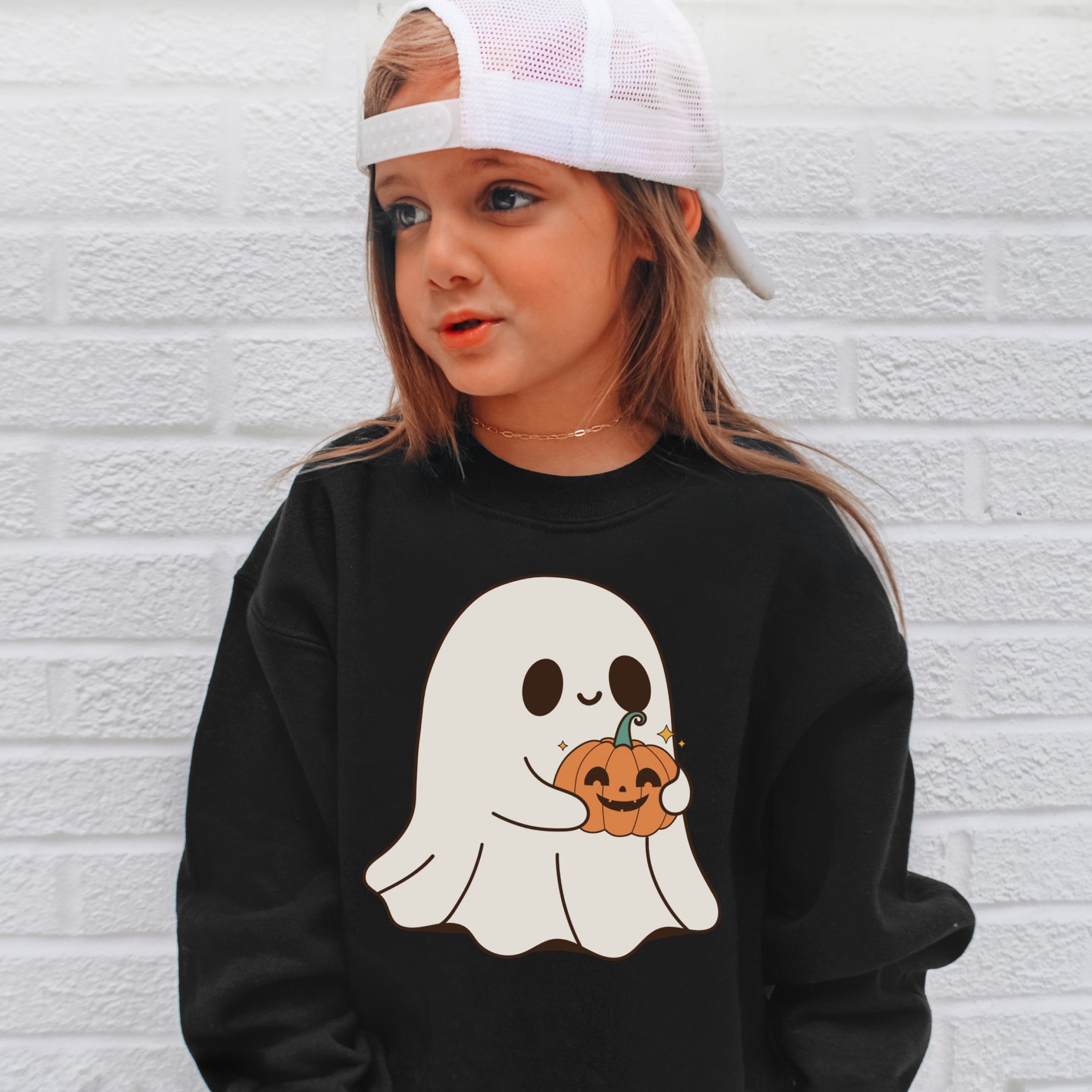 Black kids cute ghost sweatshirt featuring a white ghost holding an orange pumpkin for halloween wear
