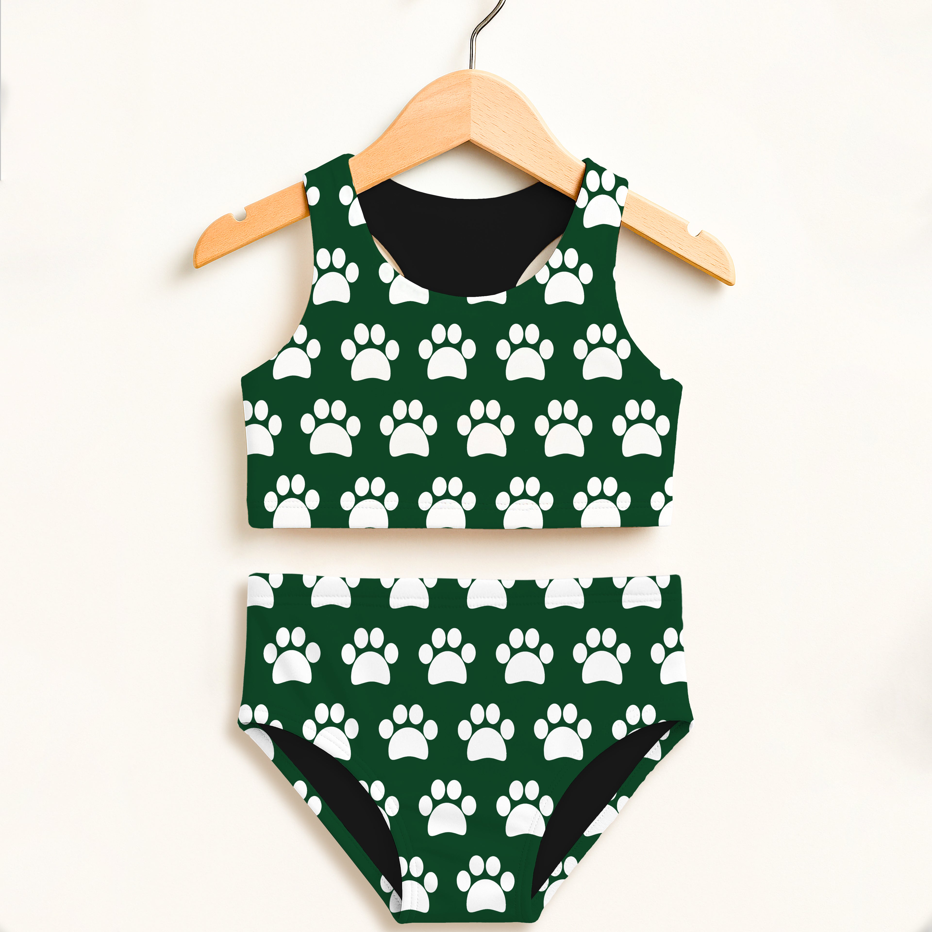 Girls dark green two piece swimsuit with white paw print pattern black lining and double layered upf 50+ fabric