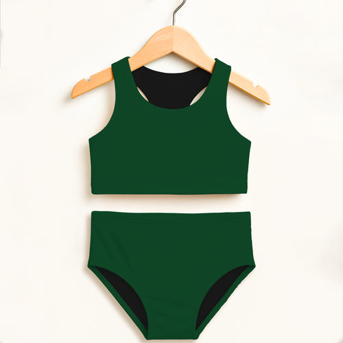 Green swimsuit with black trim on a wooden hanger against a white background