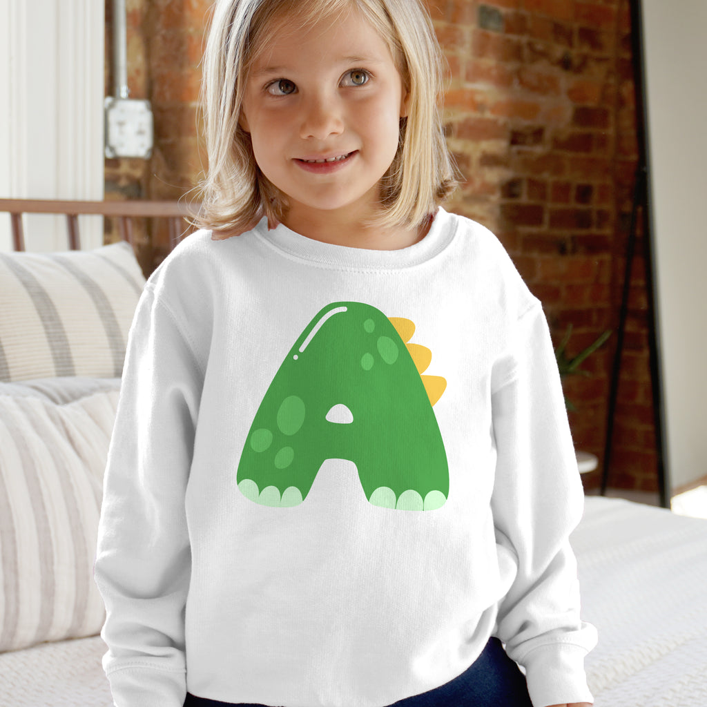 White long-sleeved sweatshirt with personalized green dinosaur letter a featuring yellow spikes and light green feet for kids