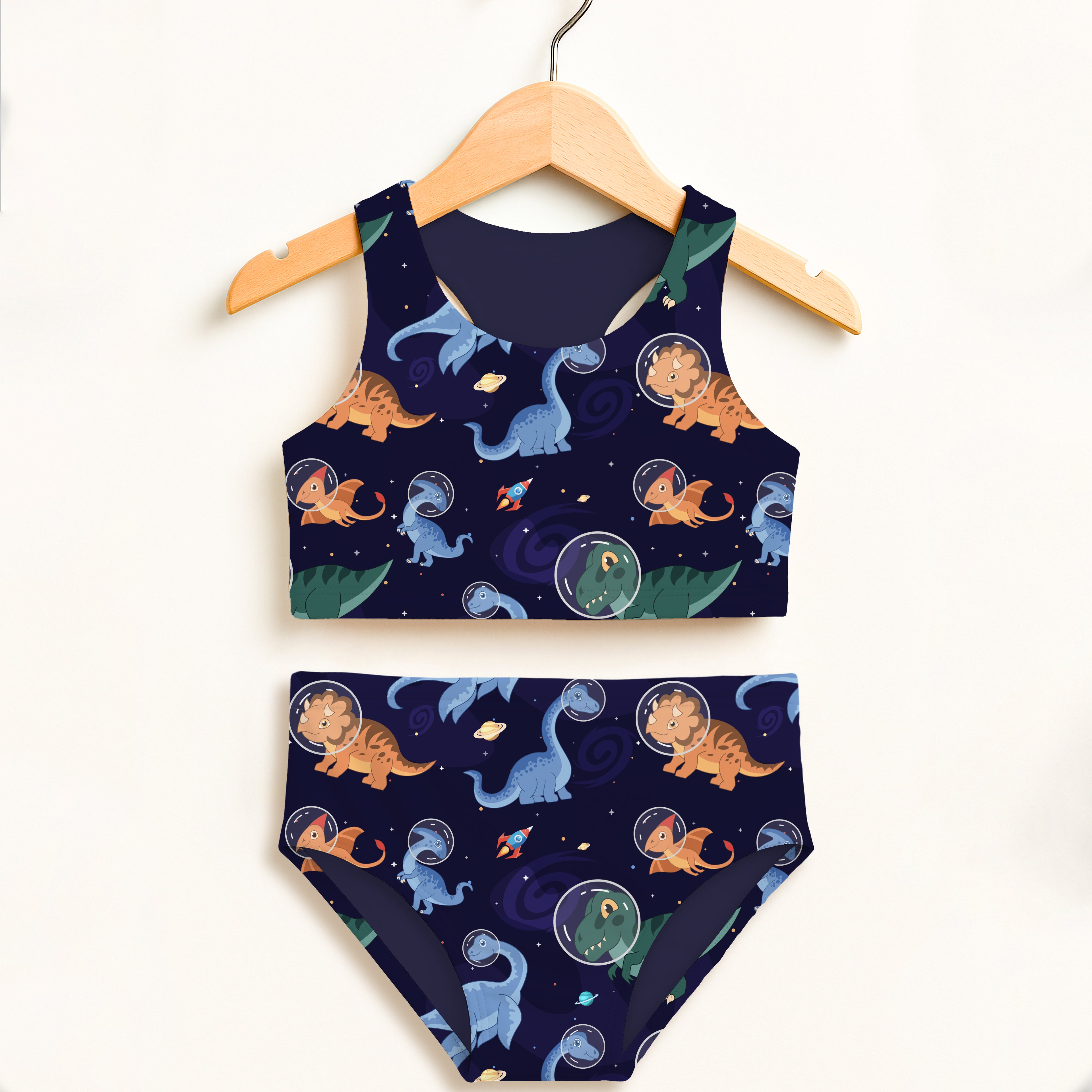 Girls space dinosaur two piece swimsuit in navy blue with cartoon dinosaurs in helmets and planets, double layered upf 50+