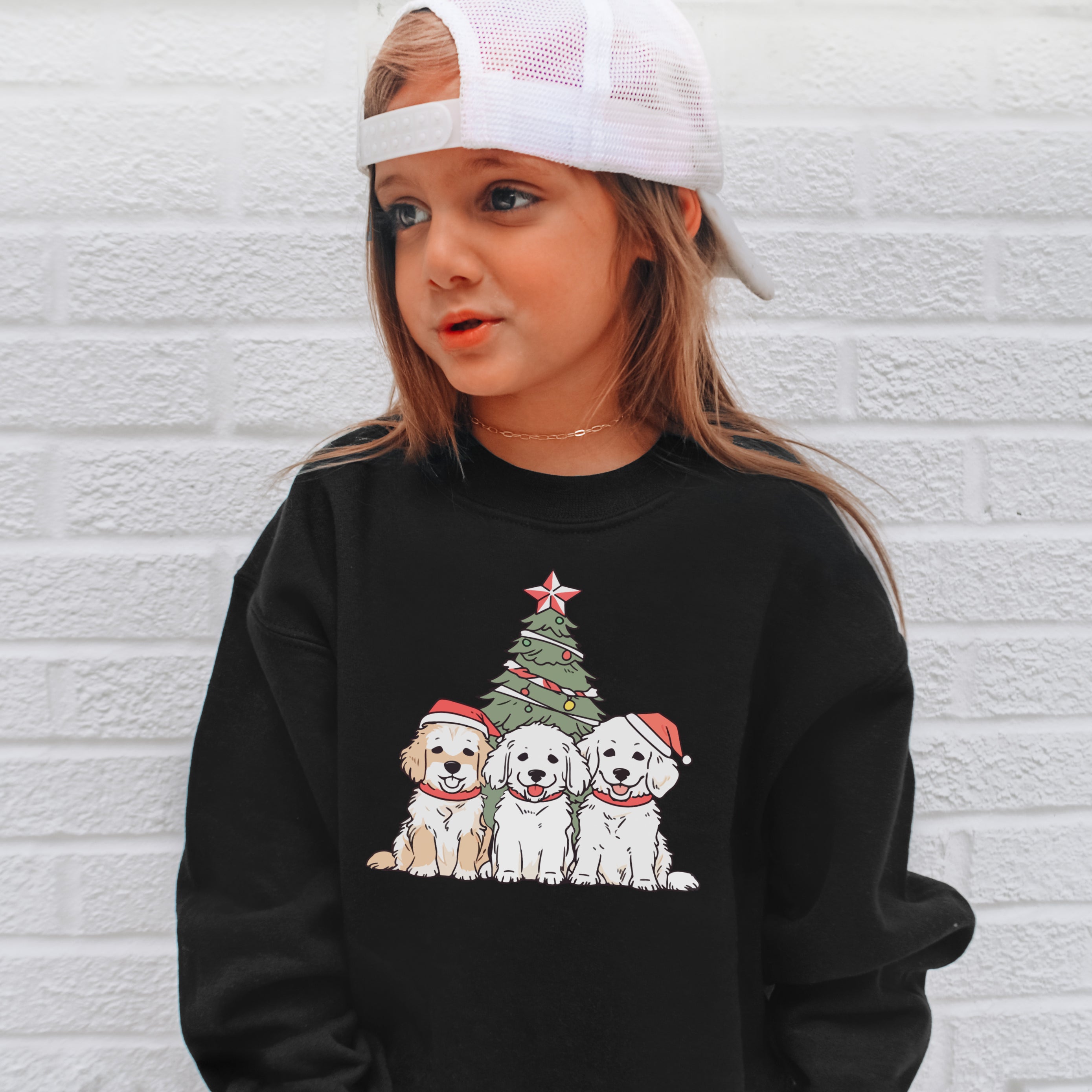 Black long-sleeved kids christmas dogs sweatshirt with festive golden retriever santa hats and decorated tree graphic