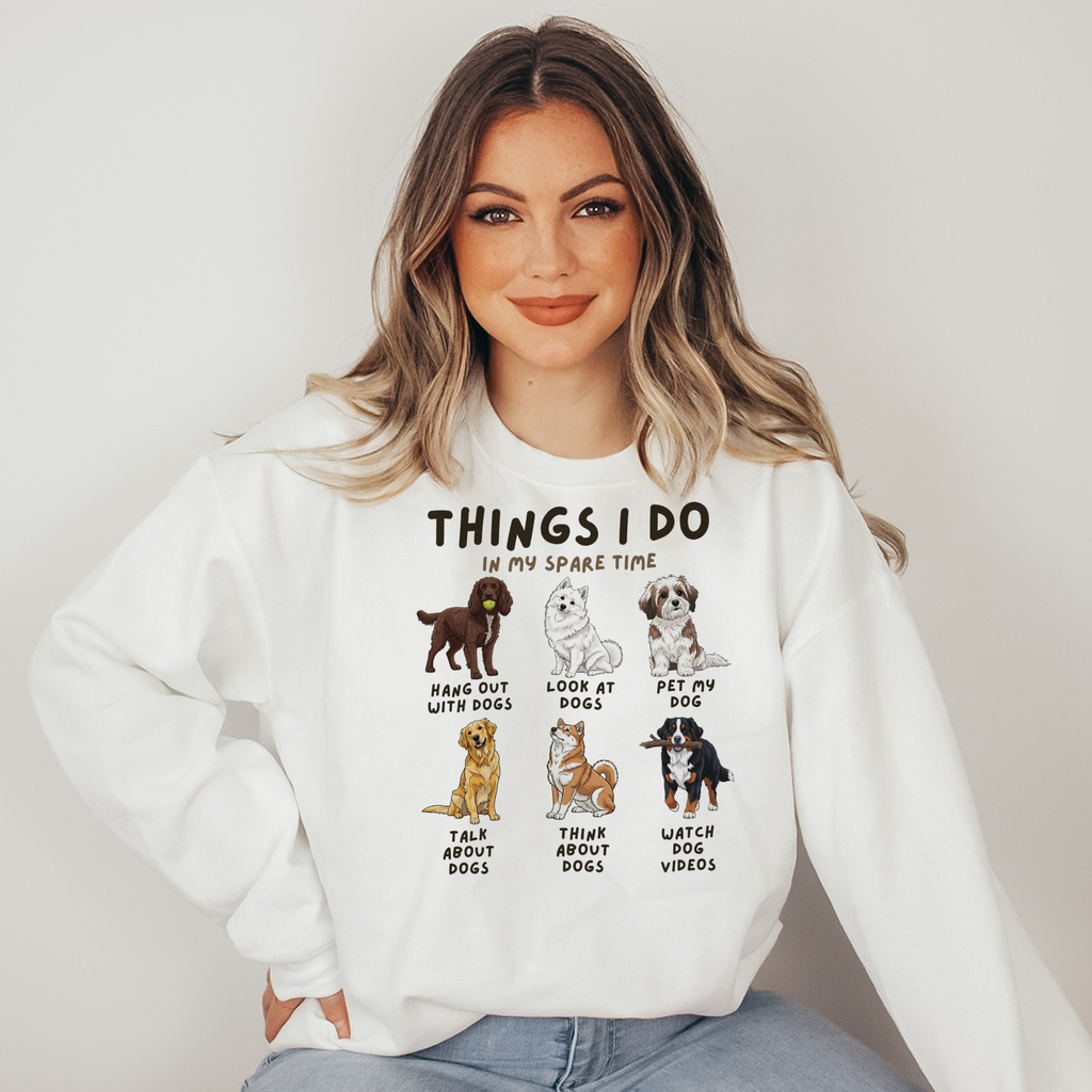 Woman wearing a white sweatshirt with dog-themed graphics and text.