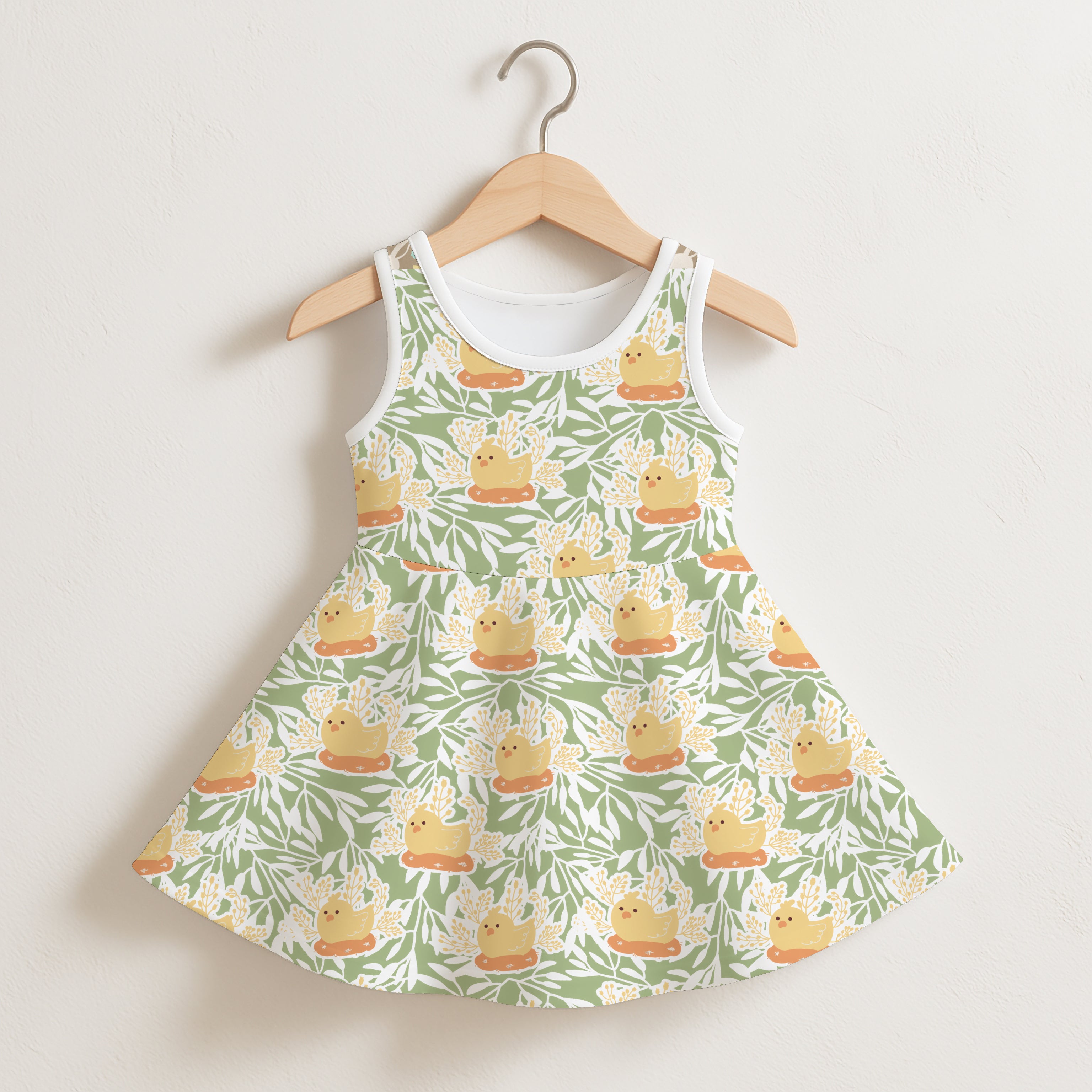 Girls Easter chick sleeveless dress in green and white with yellow rubber duck pattern on orange platforms hanging on wood hanger