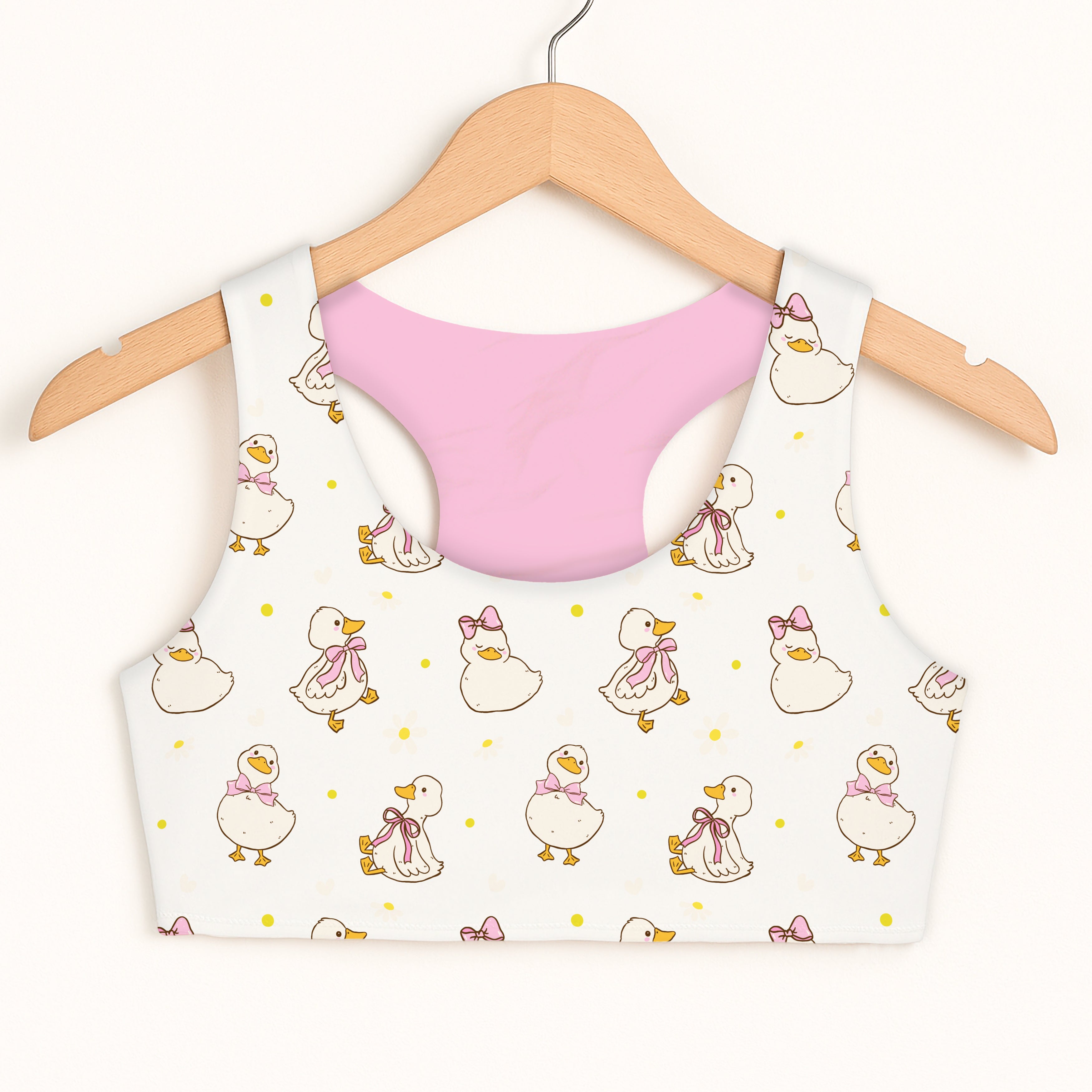 Girls easter duck sports bra in white with playful cartoon ducks pattern and soft pink quick drying lining