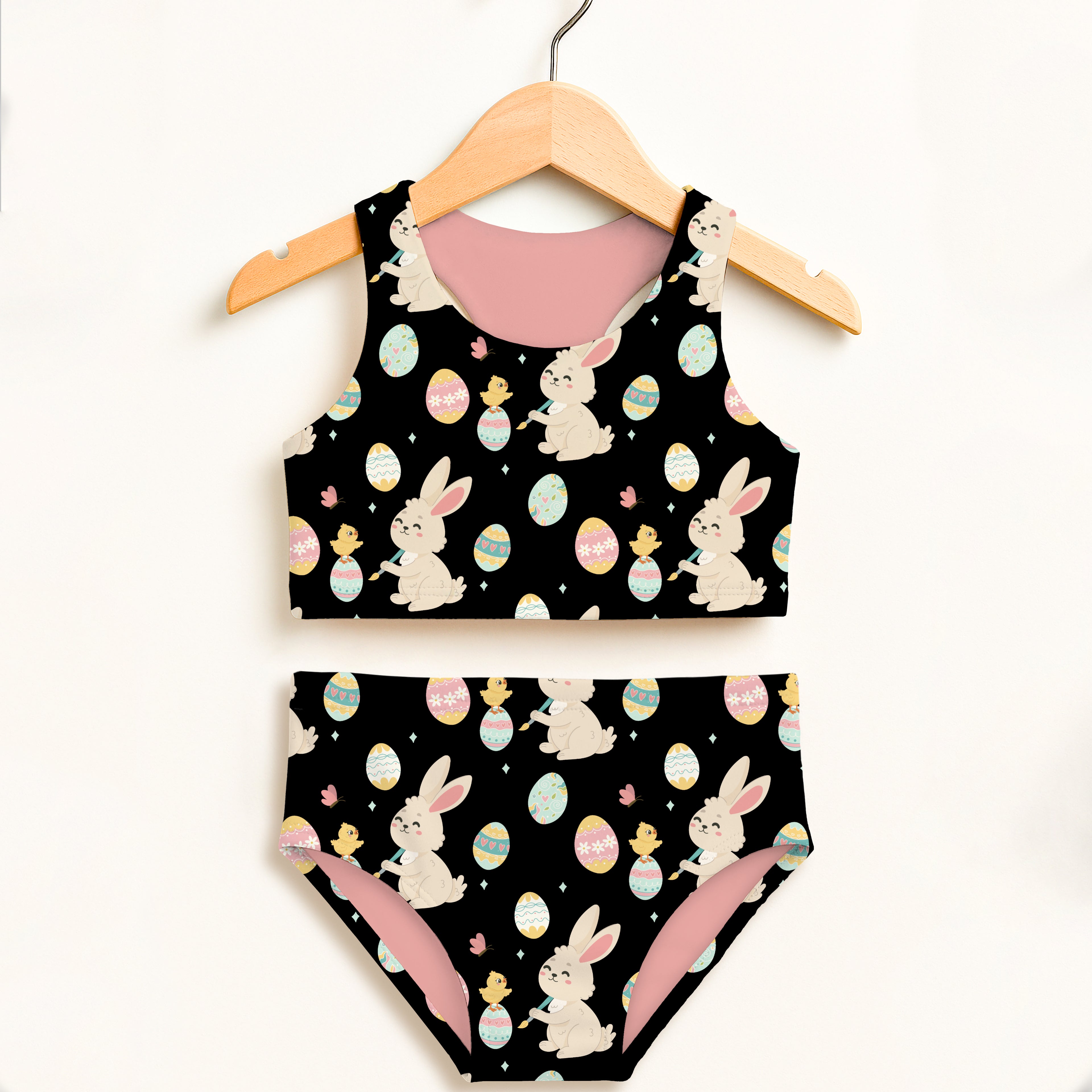 Girls black Easter bunny and chick two piece swimsuit with pink lining featuring cartoon bunnies and colorful eggs