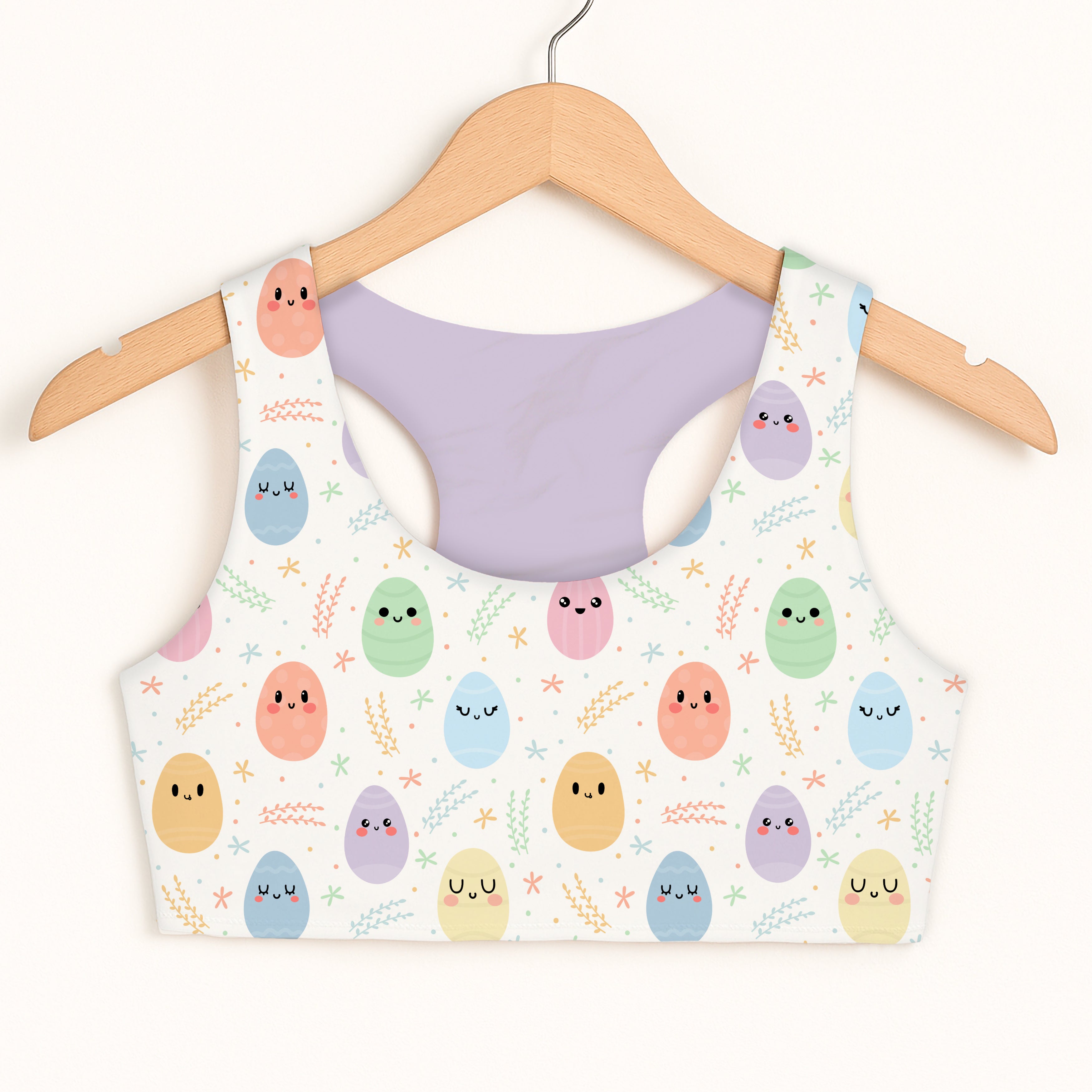 White girls smiling easter egg sports bra with pastel pattern quick drying double layered comfort and greenery accents