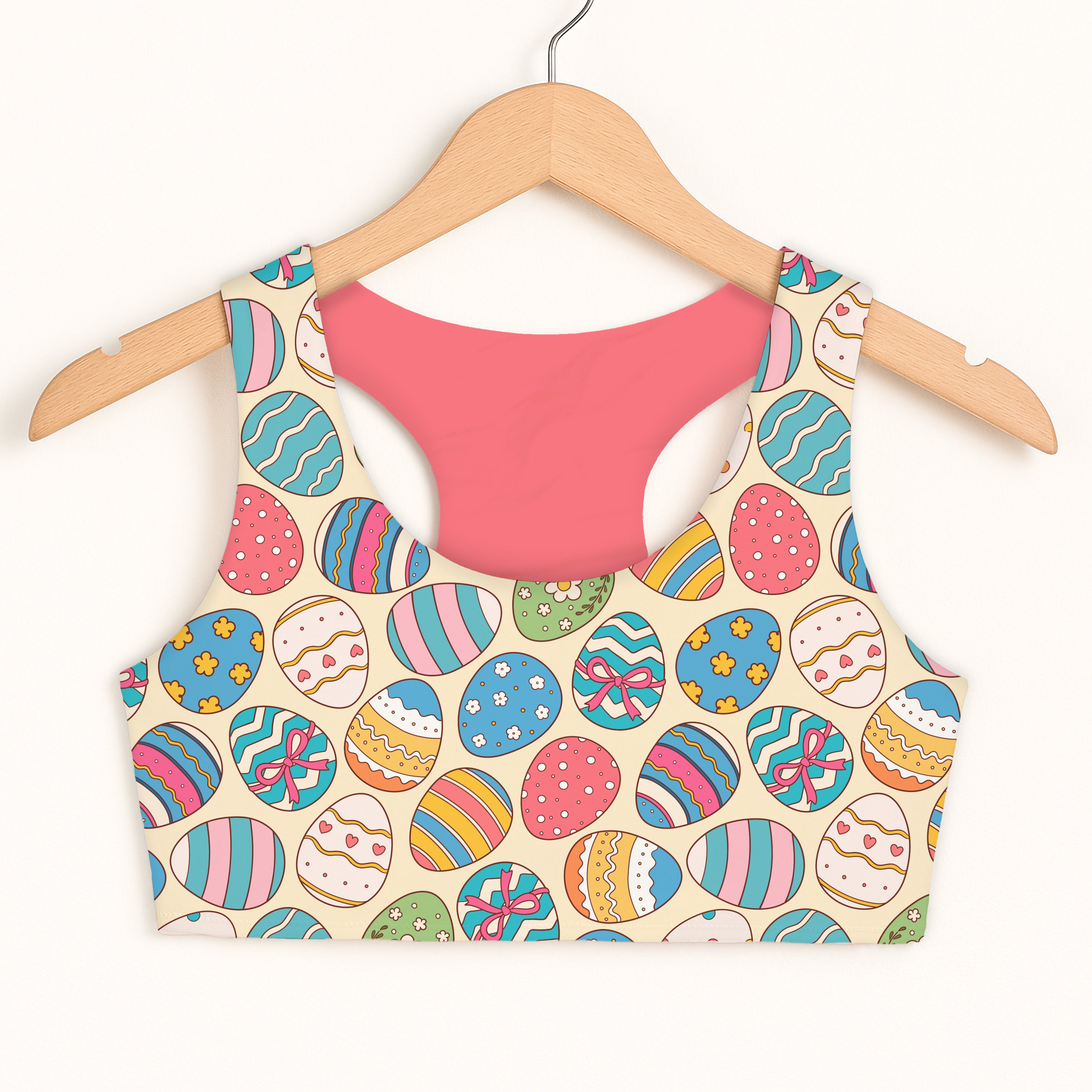 Girls easter egg sports bra with colorful egg pattern, pink interior, quick drying, double layered comfort on cream background