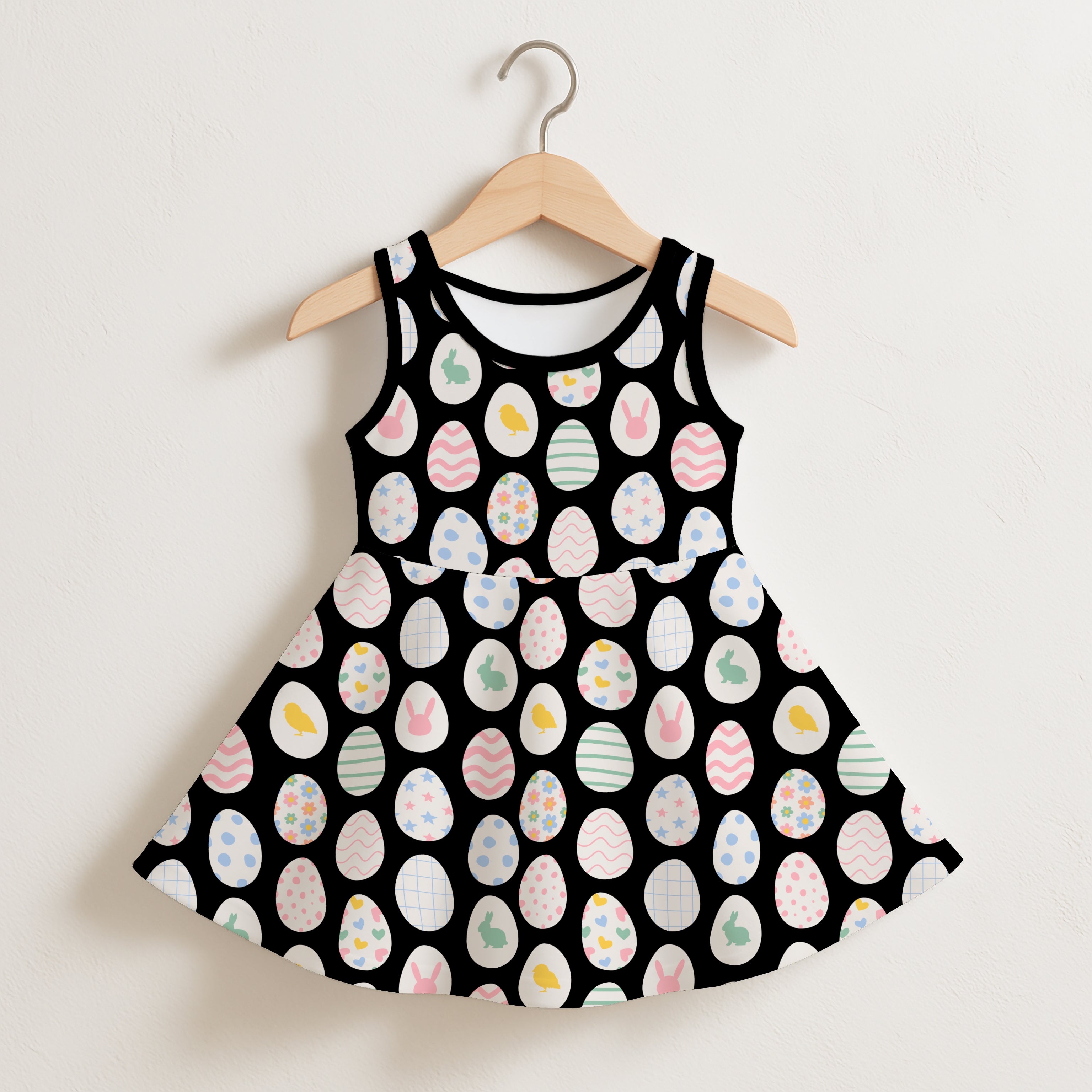 Girls easter egg sleeveless dress in black with pastel-colored easter eggs and bunnies playful pattern