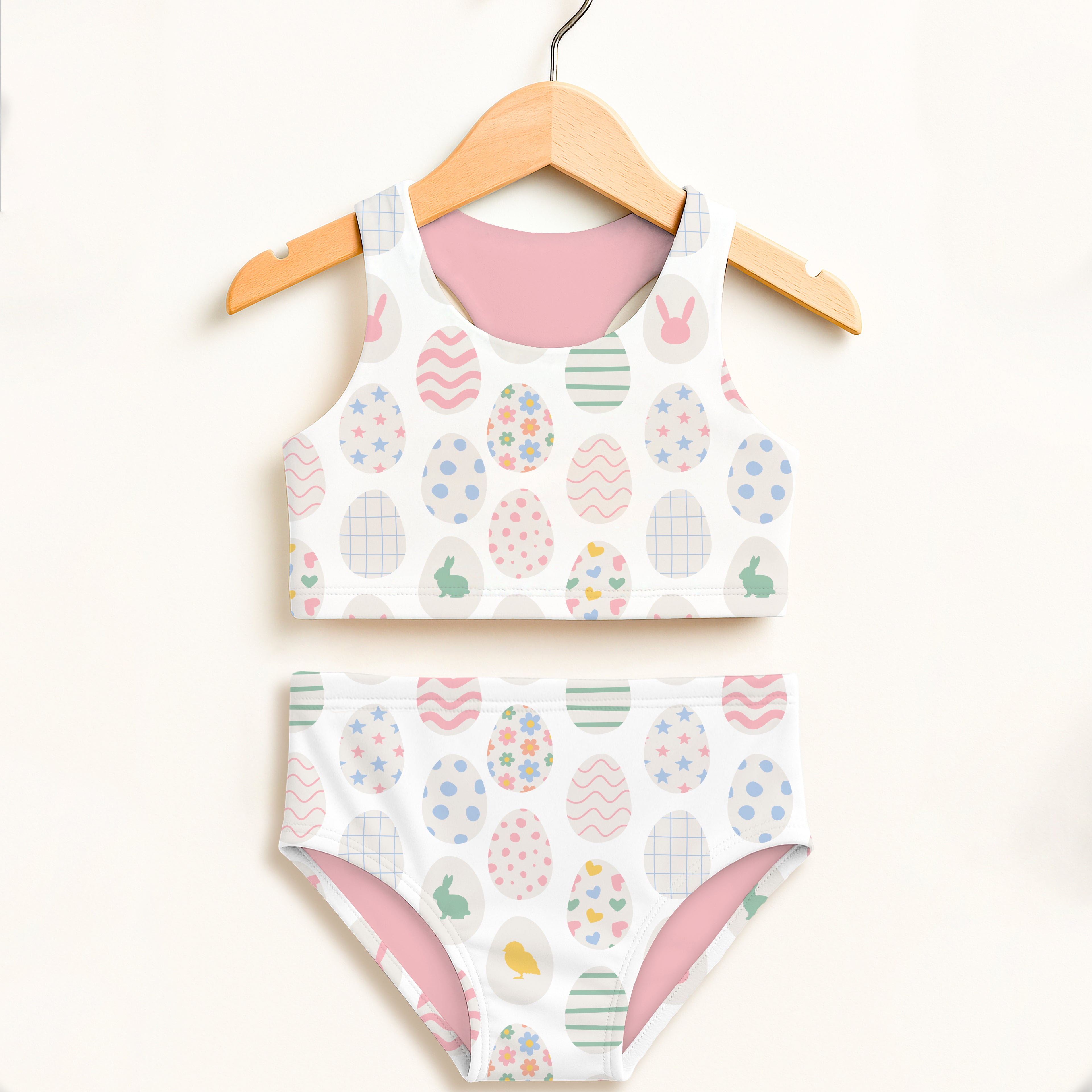 Girls white two-piece swimsuit with pastel easter egg and bunny patterns pink lining double layered upf 50+ high waisted