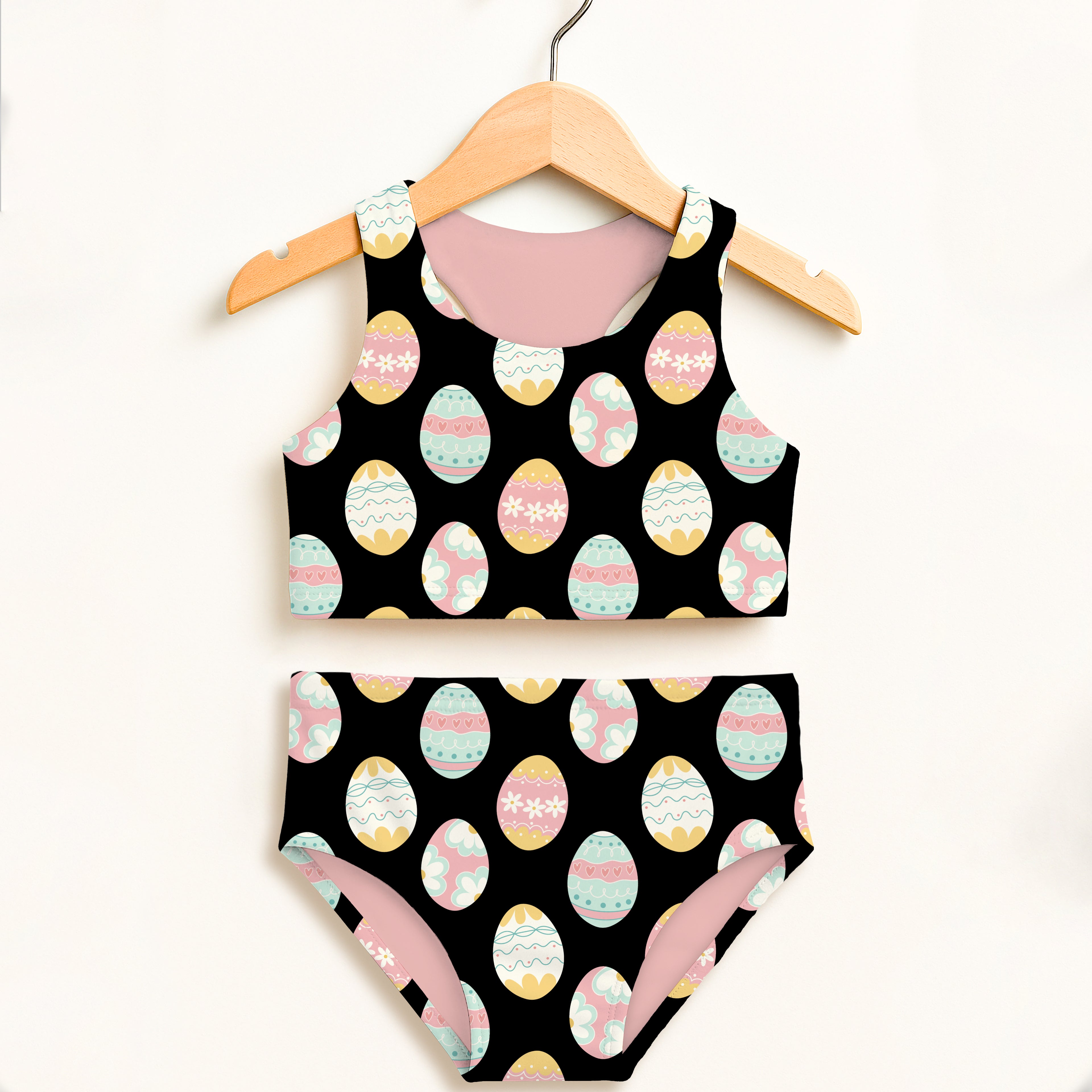 Girls black easter egg two piece swimsuit with playful pastel eggs and double layered upf 50 plus high waisted design