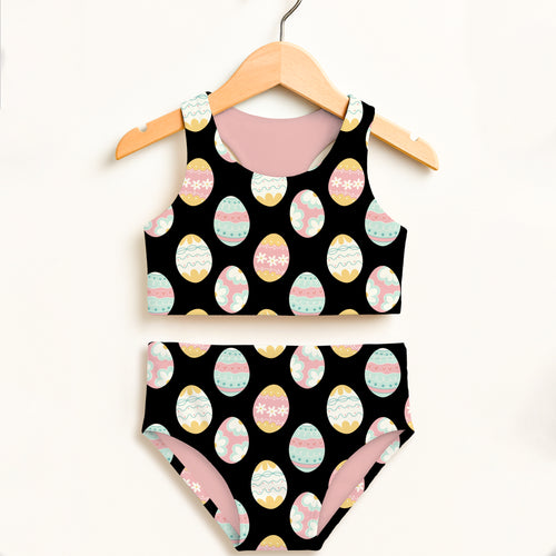 Girls black easter egg two piece swimsuit with playful pastel eggs and double layered upf 50 plus high waisted design
