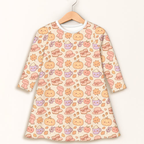 Girls fall pumpkin long sleeve dress in soft cream with kawaii smiling pumpkins cozy hats and steaming mugs pattern