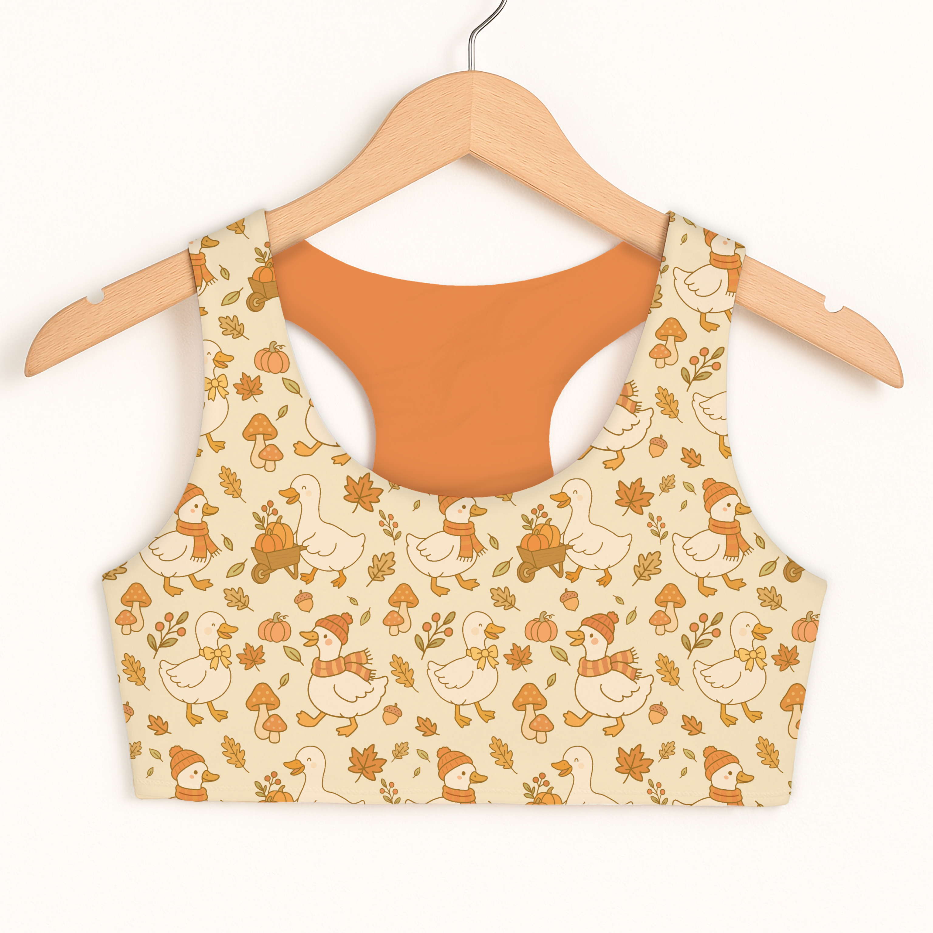 Beige girls fall ducks sports bra with quick drying fabric and playful autumn ducks pumpkins and leaves pattern