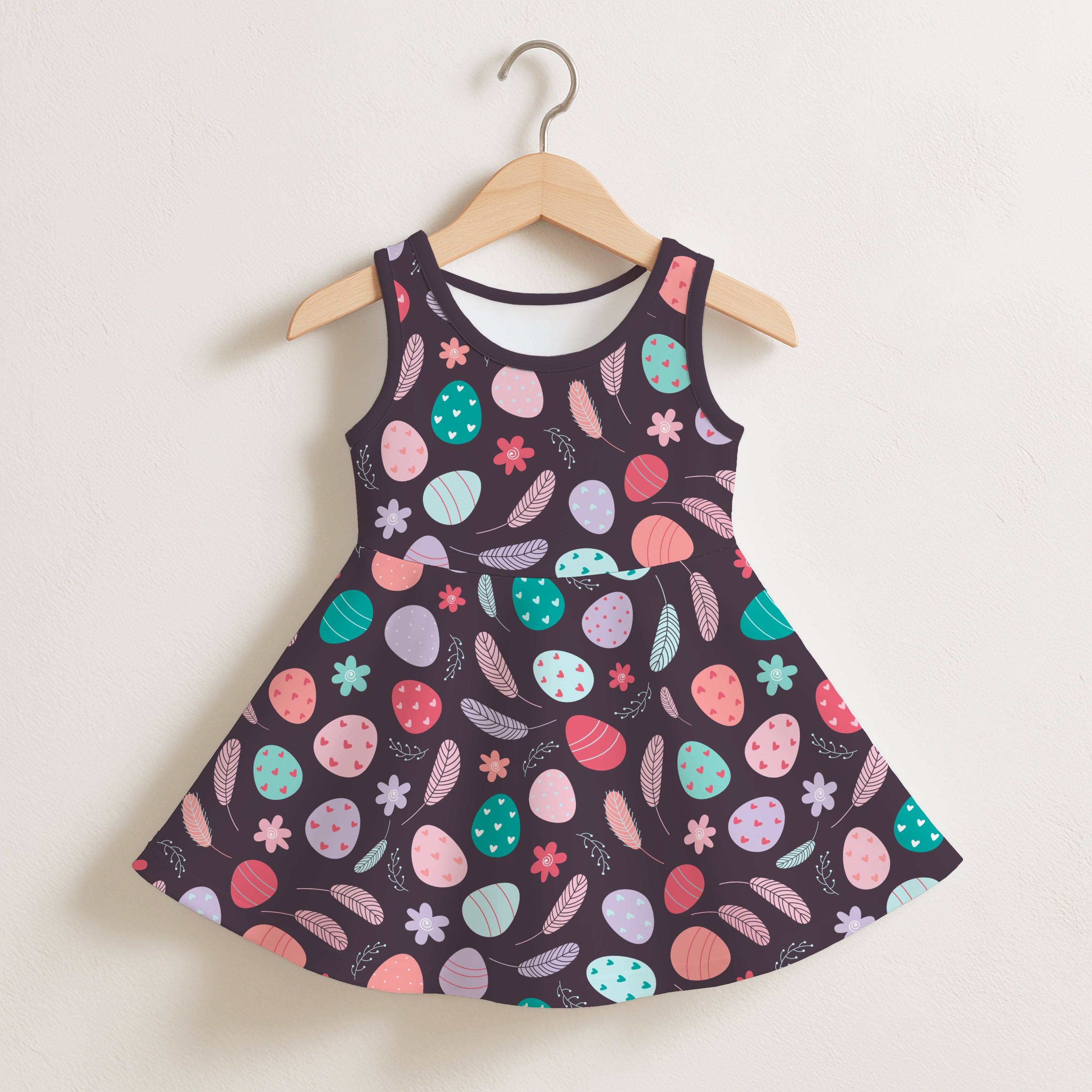 Girls dark floral easter egg sleeveless dress in black with a flared skirt and pastel easter egg patterns