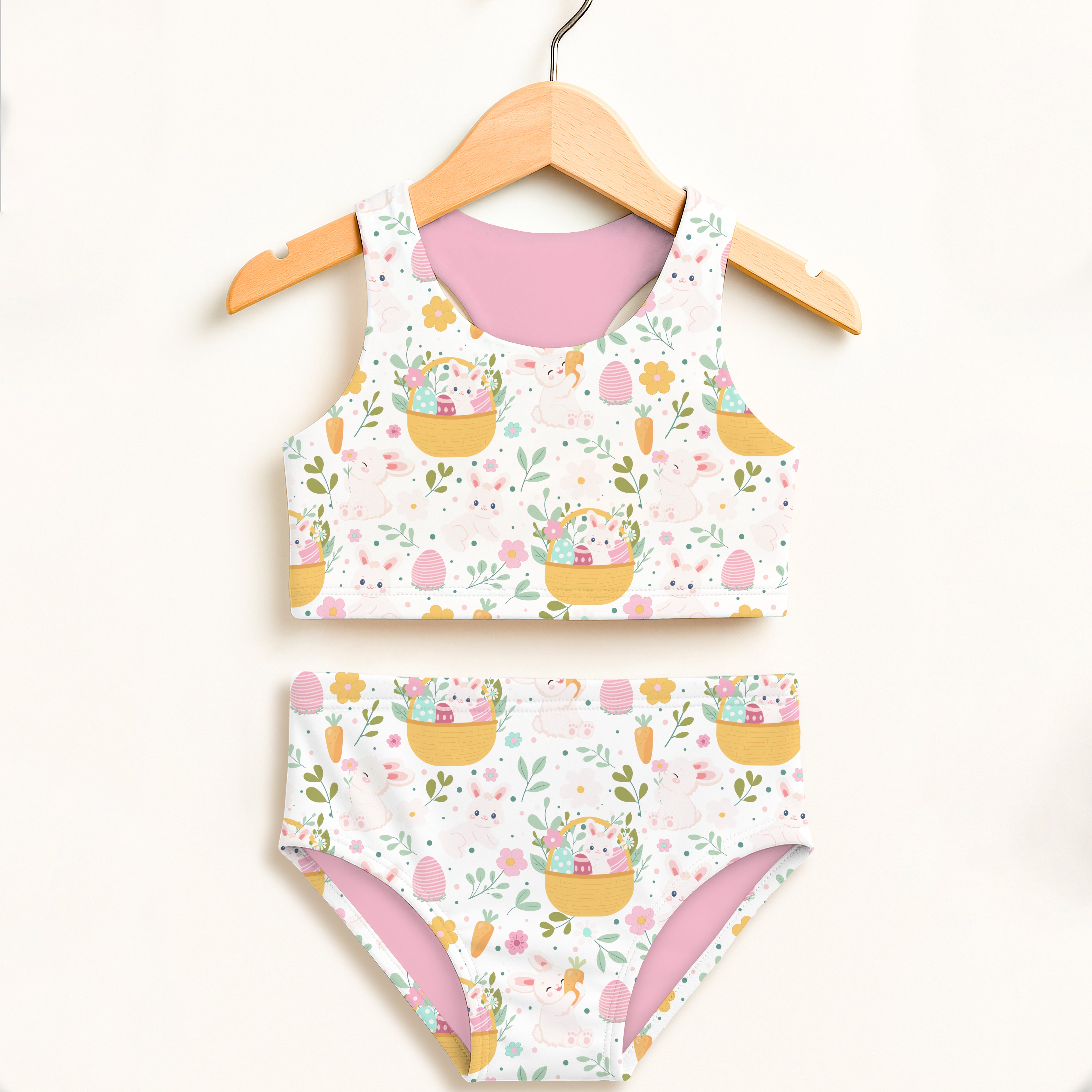 Girls easter basket bunny two piece swimsuit with pastel yellow baskets colorful eggs pink bunnies white base and pink lining