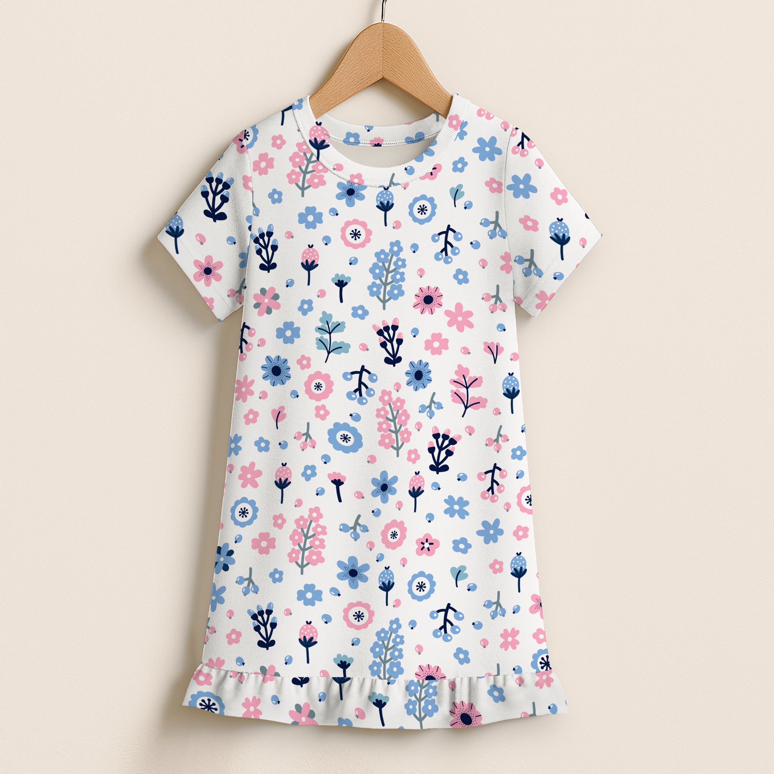 Girls pink and blue floral short sleeve dress with white fabric and a ruffled hem featuring green stems and flowers