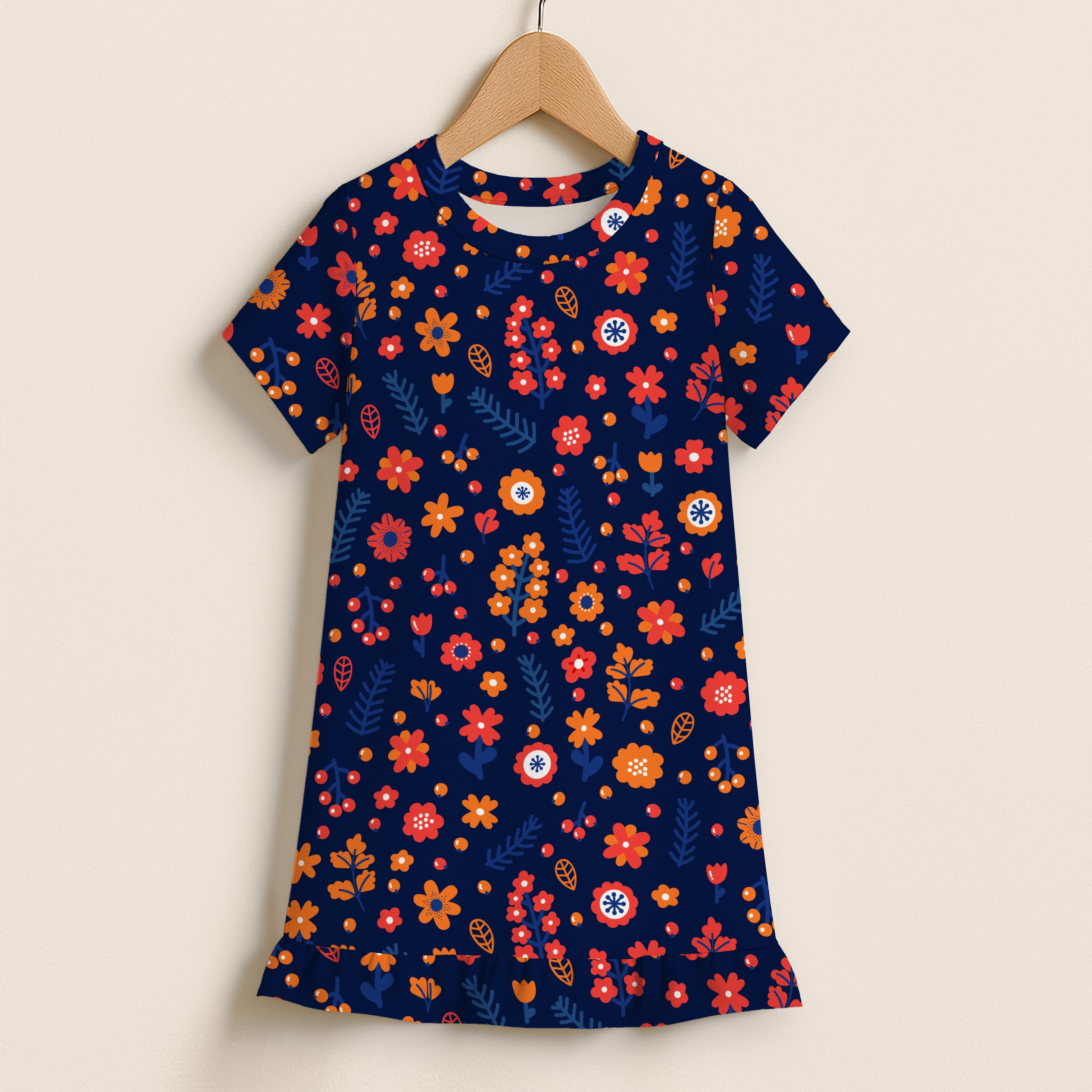 A navy blue girls floral print short sleeve dress with vibrant red orange yellow flowers and ruffle hem