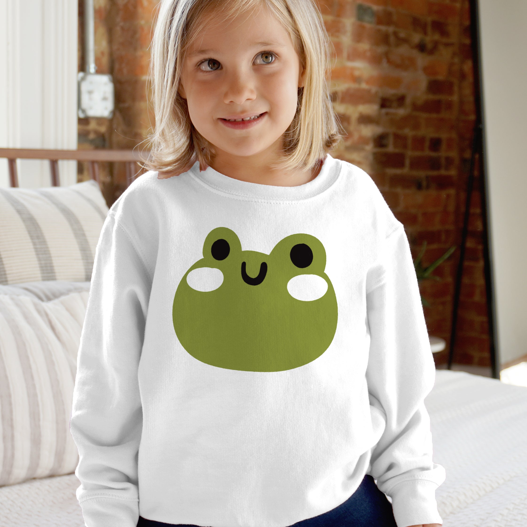 White long-sleeved kids sweatshirt with soft fleece featuring a cartoon green frog face for little animal lovers