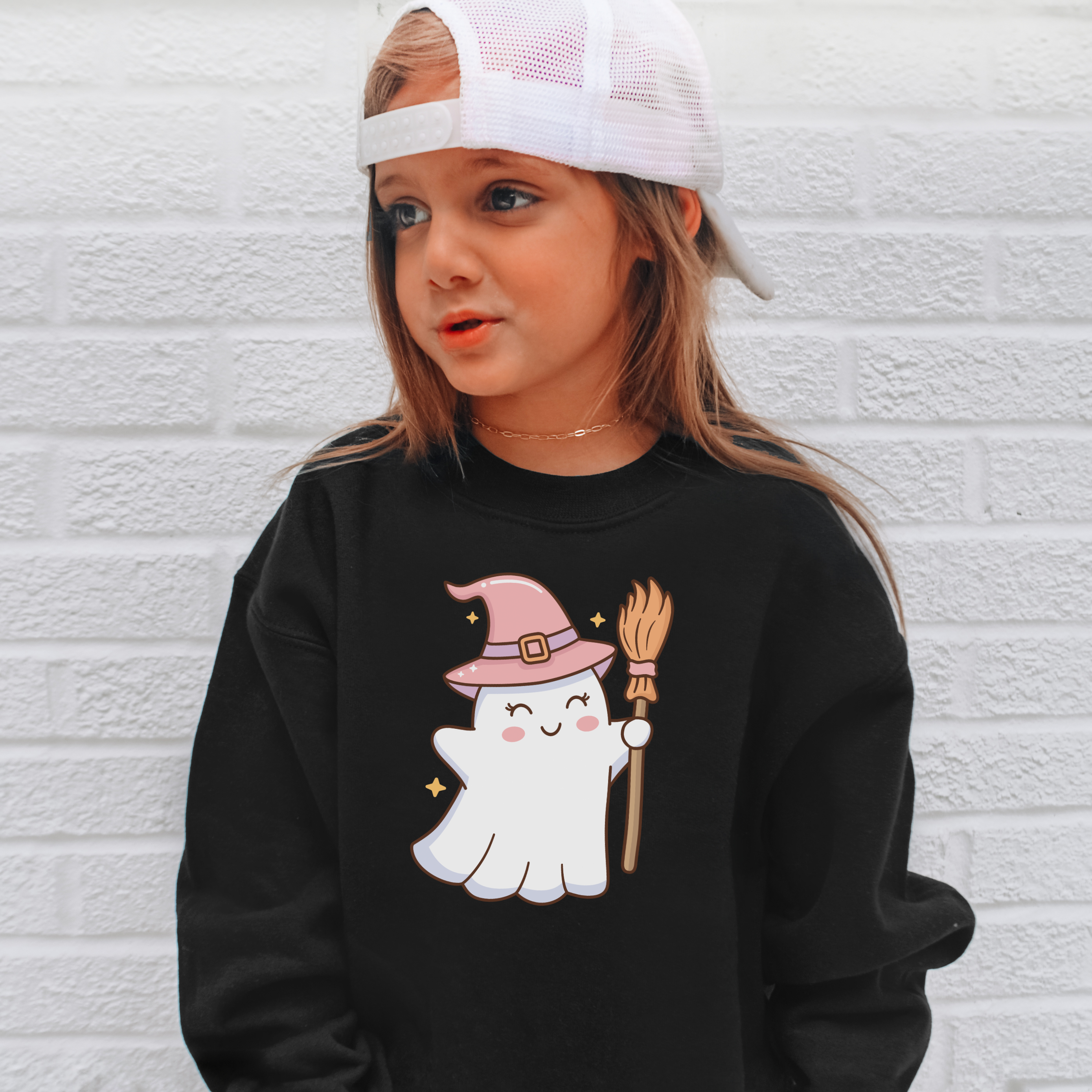 Black long-sleeved kids sweatshirt with cute white ghost wearing pink witch hat and holding broomstick for halloween