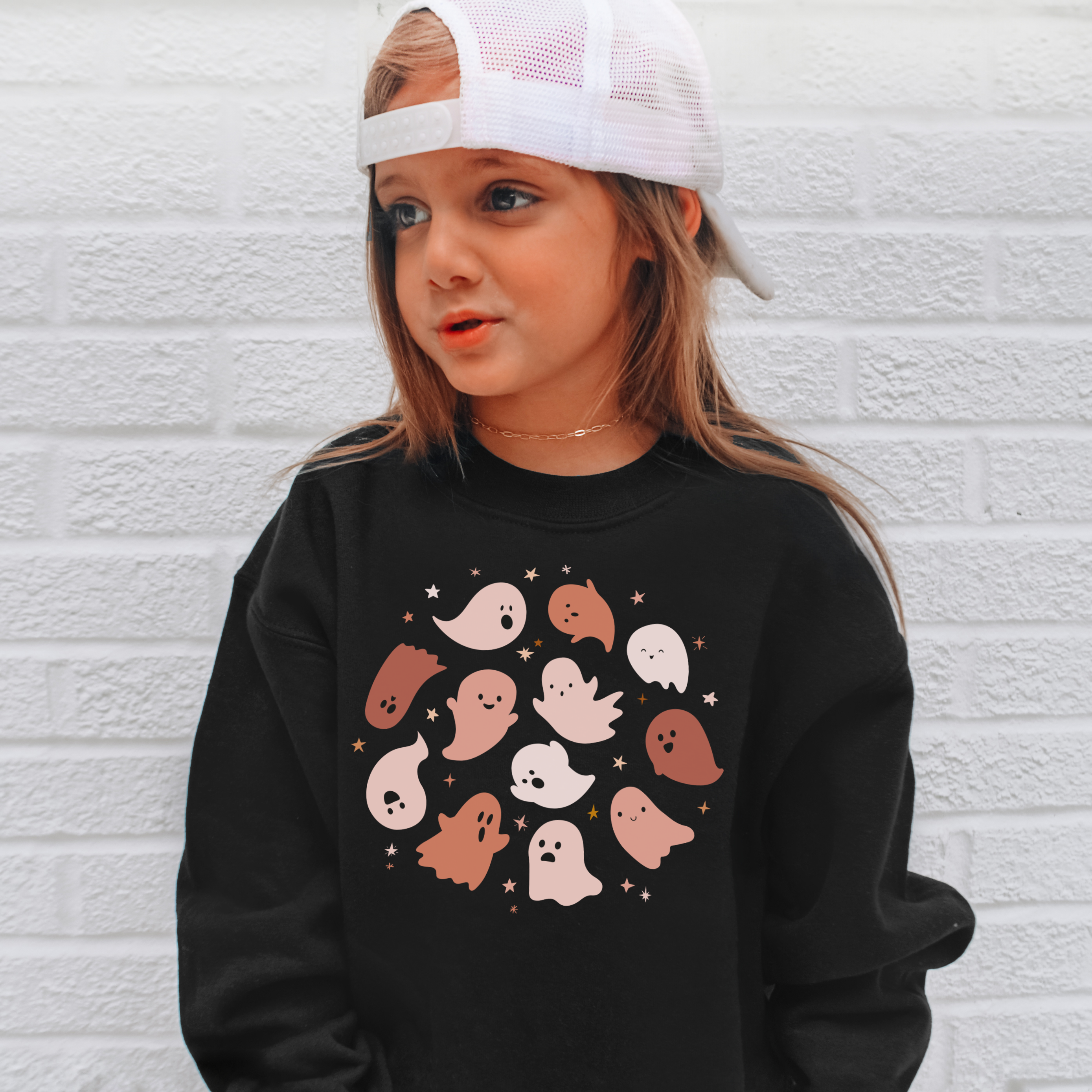 Black long-sleeved sweatshirt with pastel-colored ghost and star pattern perfect for kids halloween wear