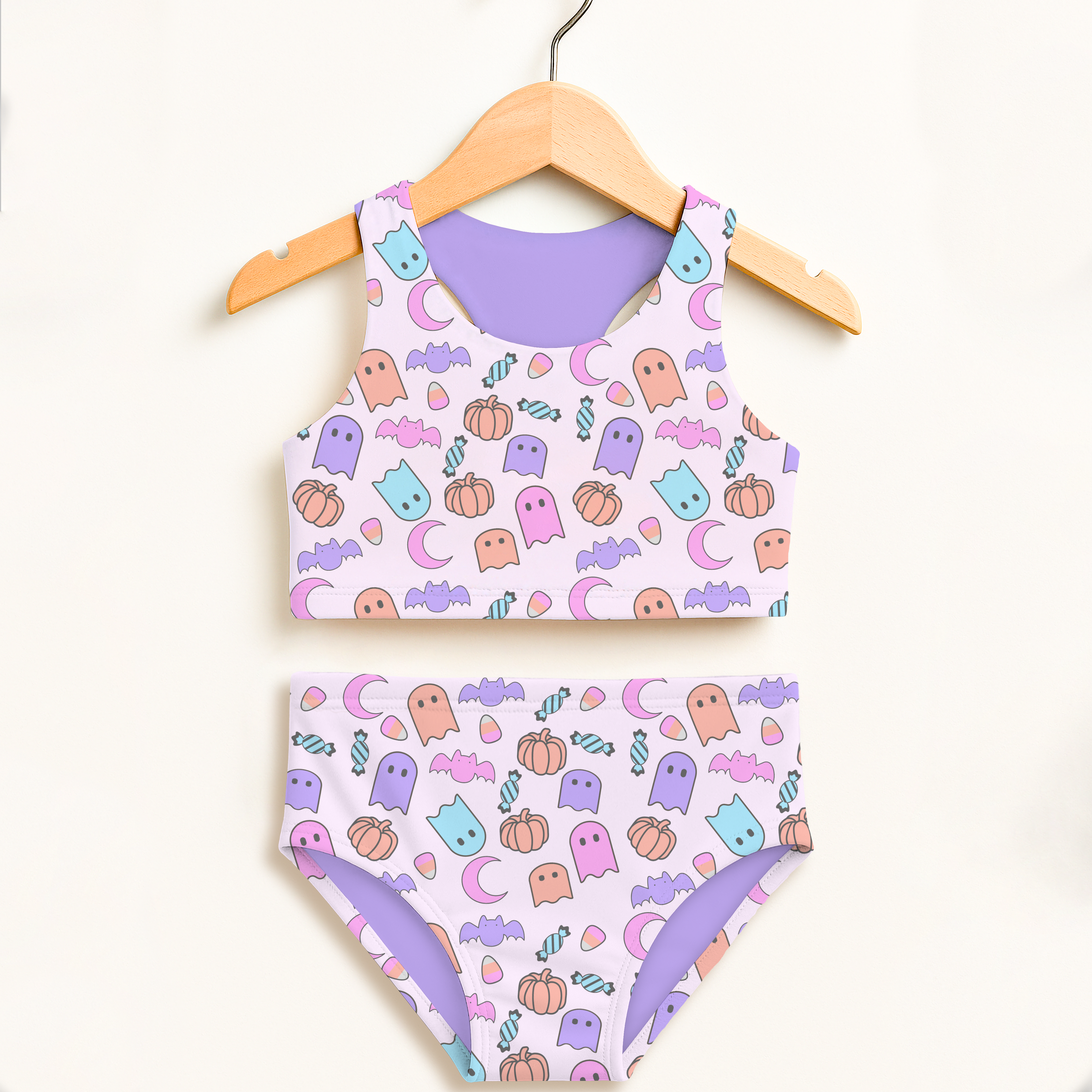 Girls pastel ghost halloween two piece swimsuit with cute ghost pumpkin bat patterns on light purple base upf 50+