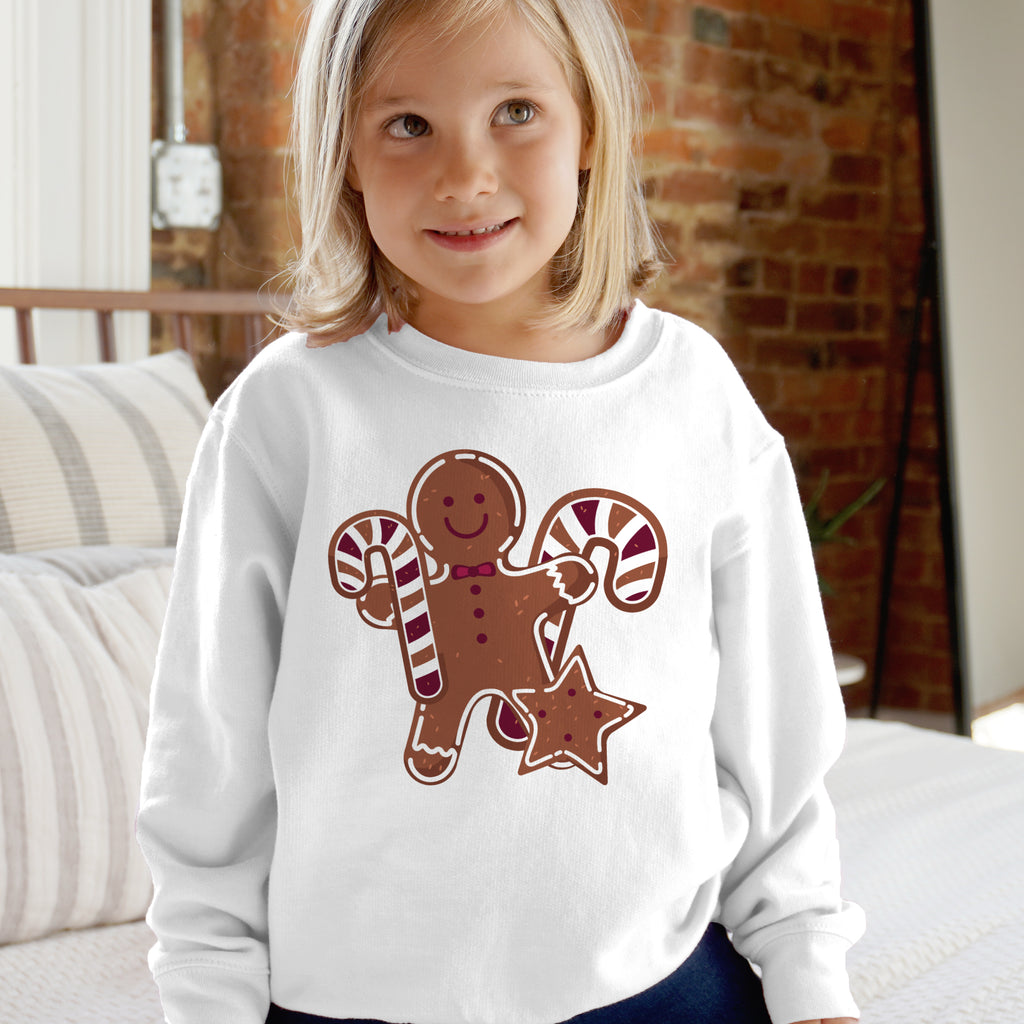 White long-sleeved kids sweatshirt with brown gingerbread man and candy canes graphic for holiday wear