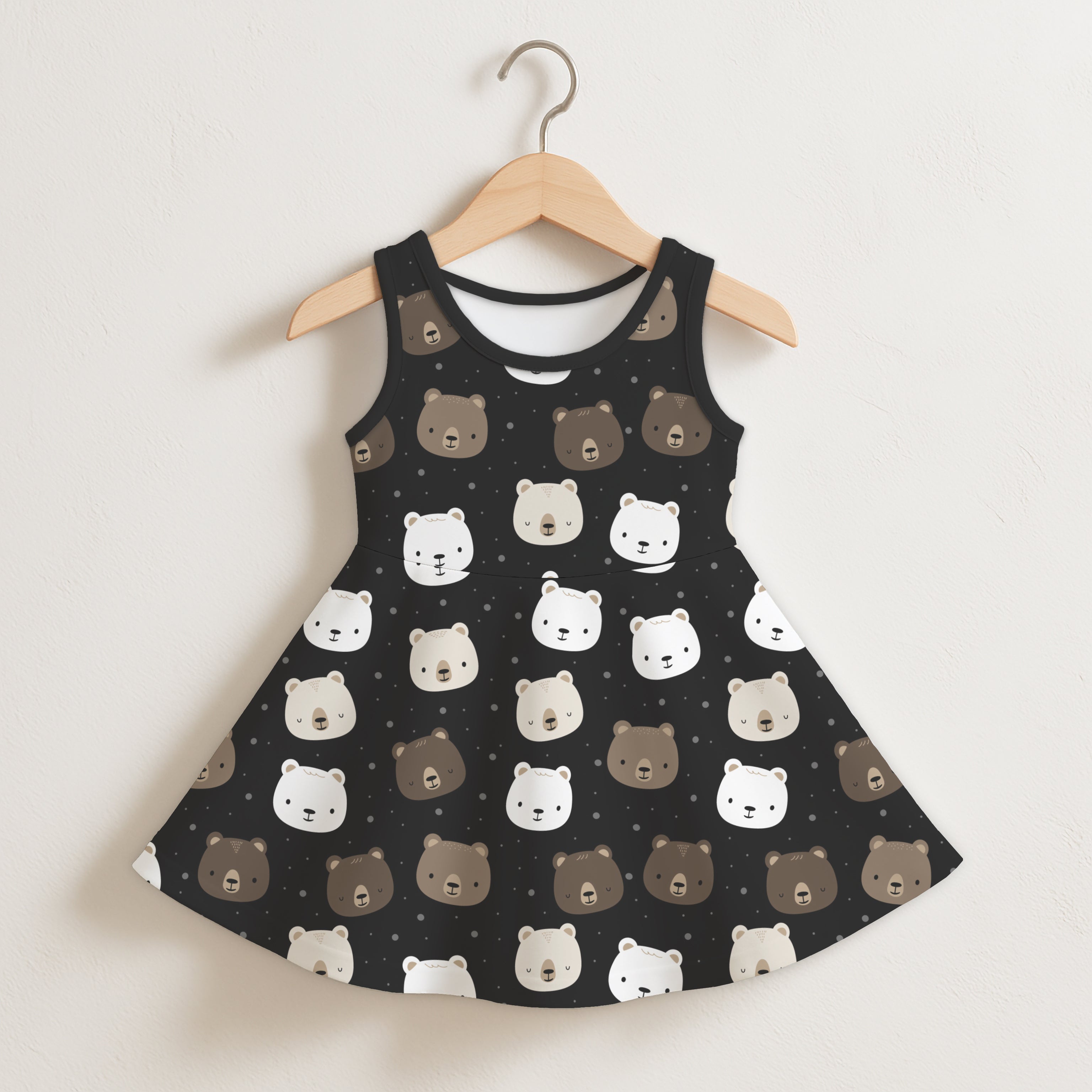 Girls bear print sleeveless dress in black with white and brown bear faces on a soft sleeveless fabric